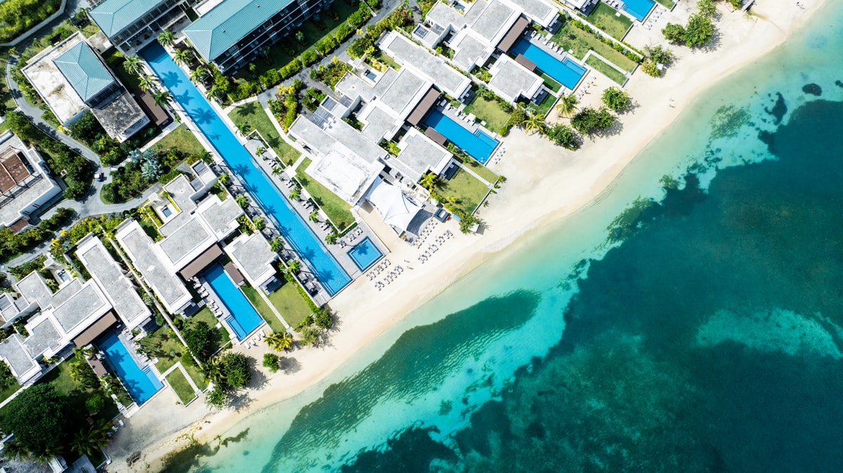 Aerial view of a luxury beach resort with pool and ocean view