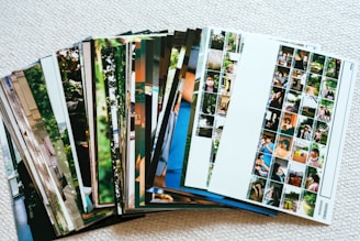 A stack of printed photographs fanned out.