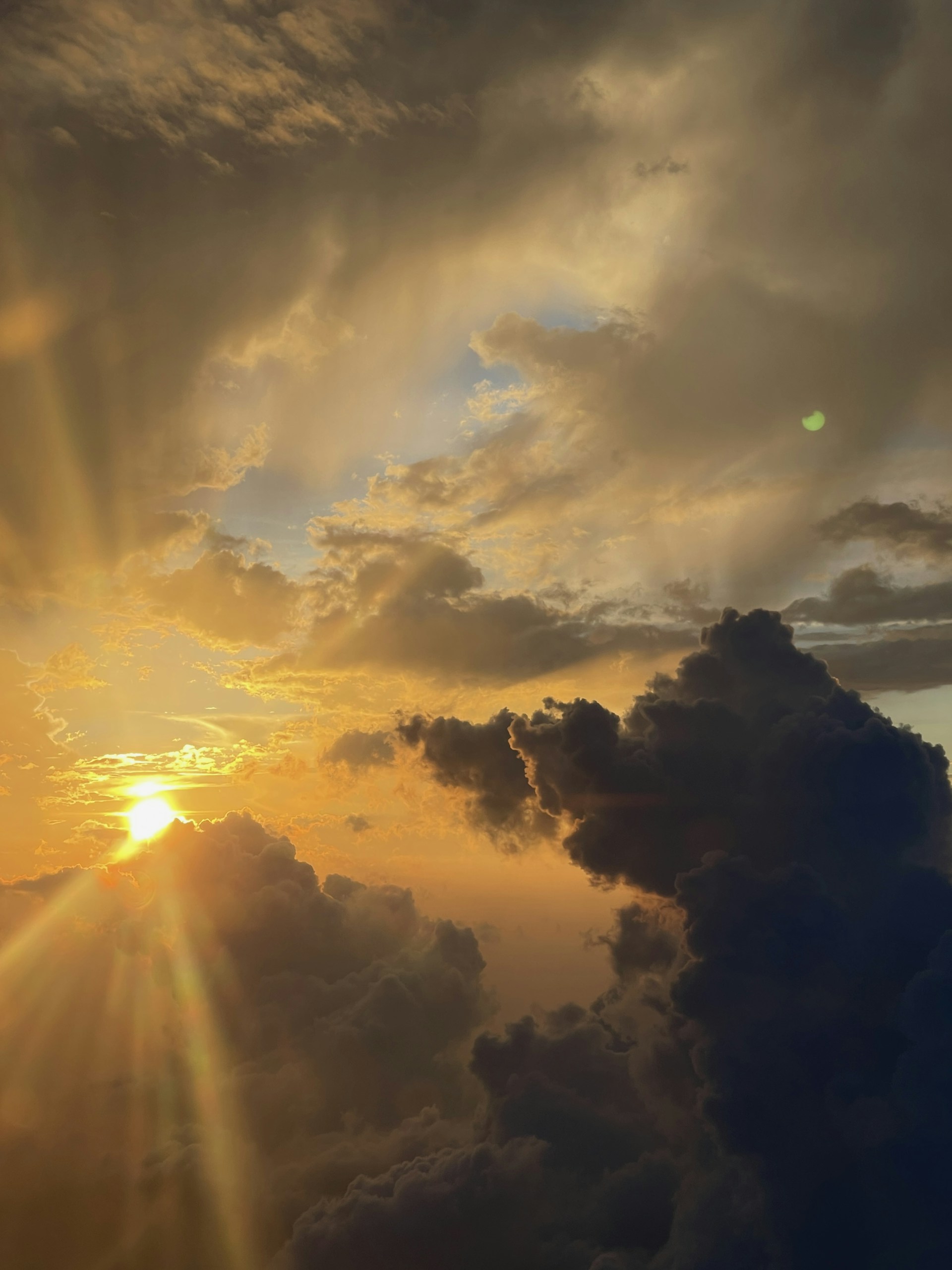 Golden sunset shining through the clouds.