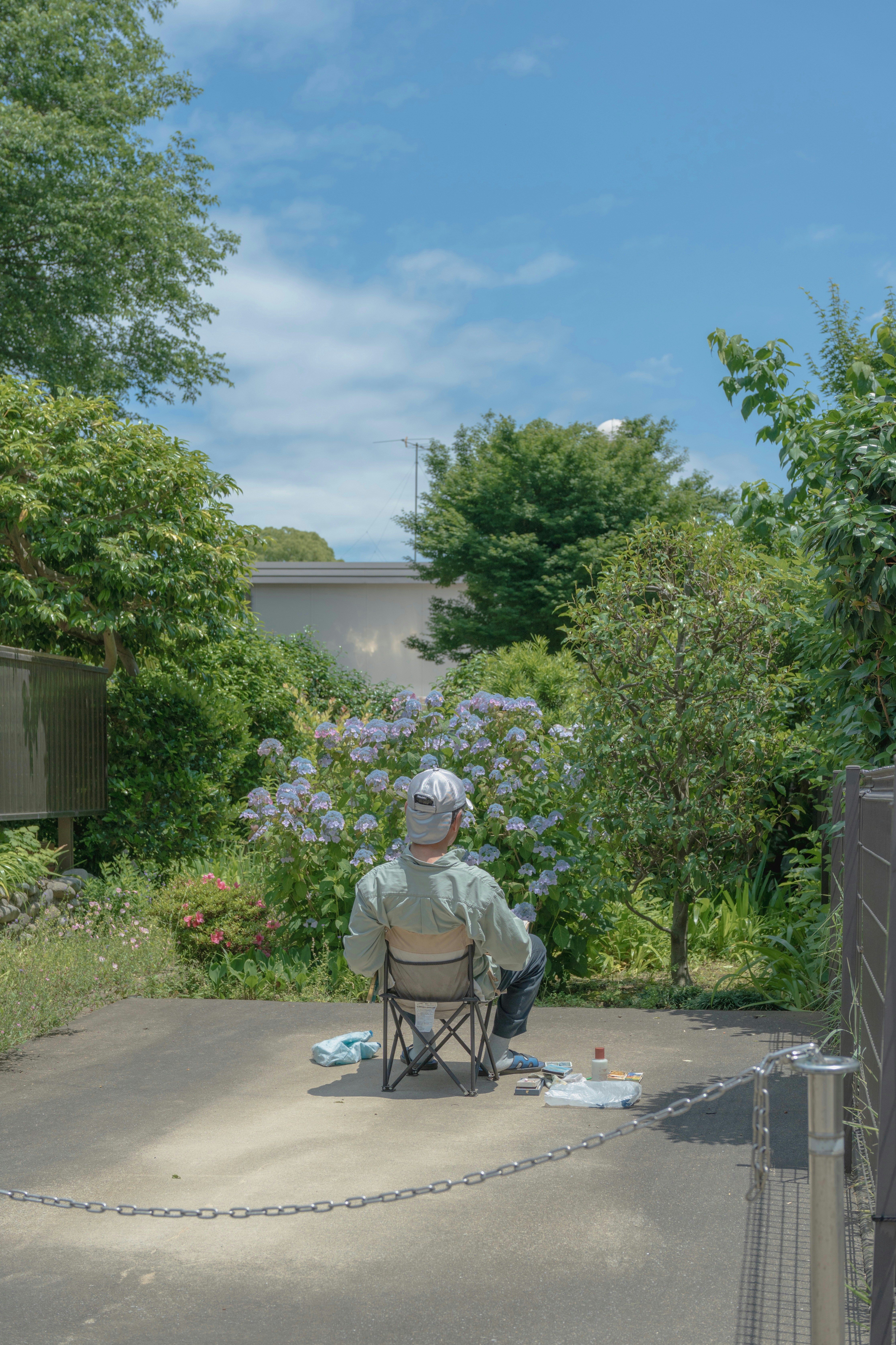 An elderly man sits and enjoys the view.
