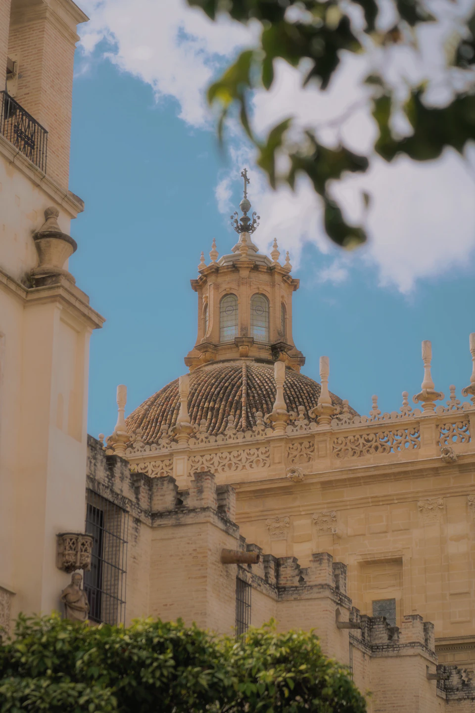Large ornate building with dome and multiple towers in light beige color stands prominently