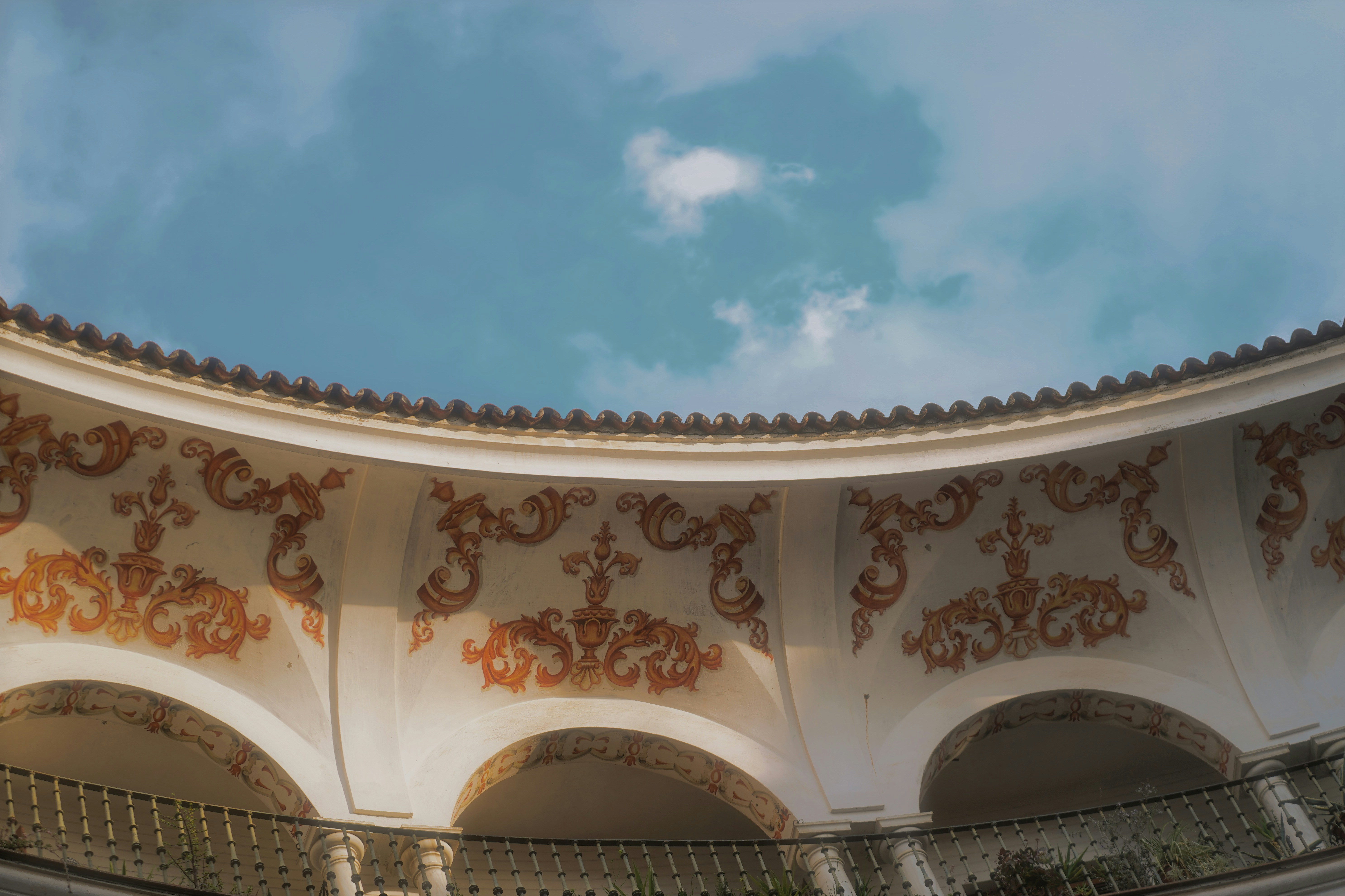 An arched building with ornate decorations is visible.