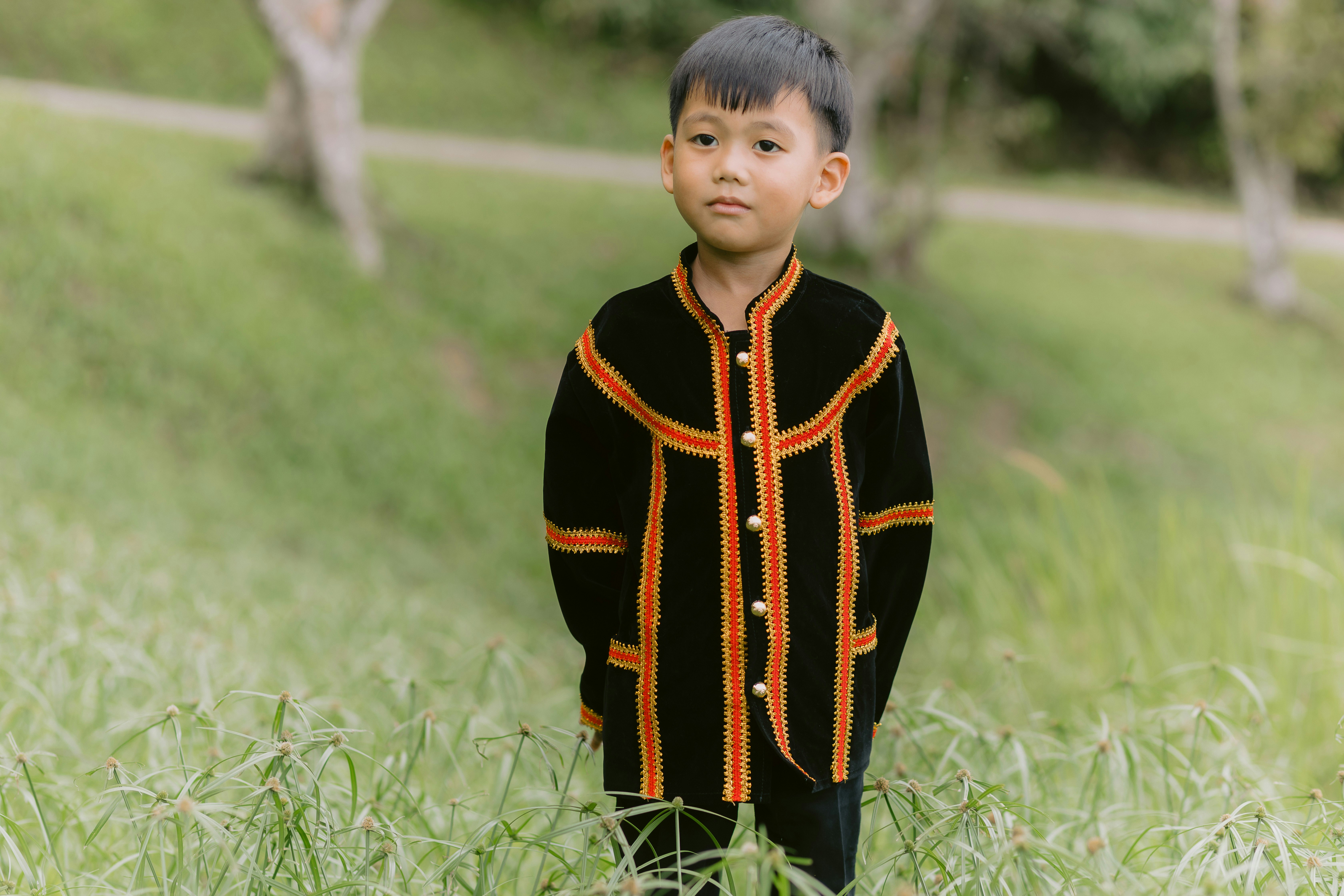 A young boy poses in traditional attire.