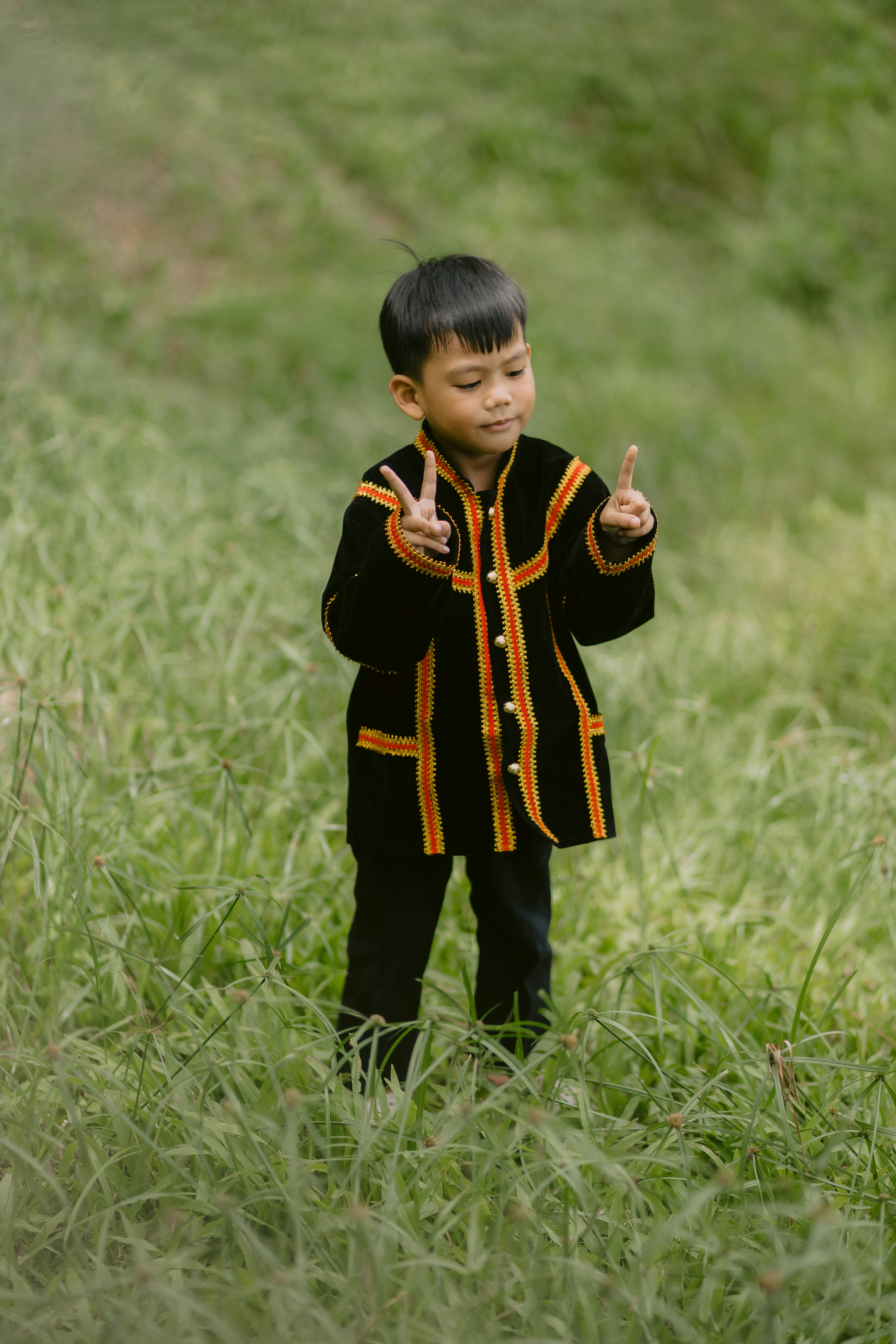 A young boy poses in traditional attire.