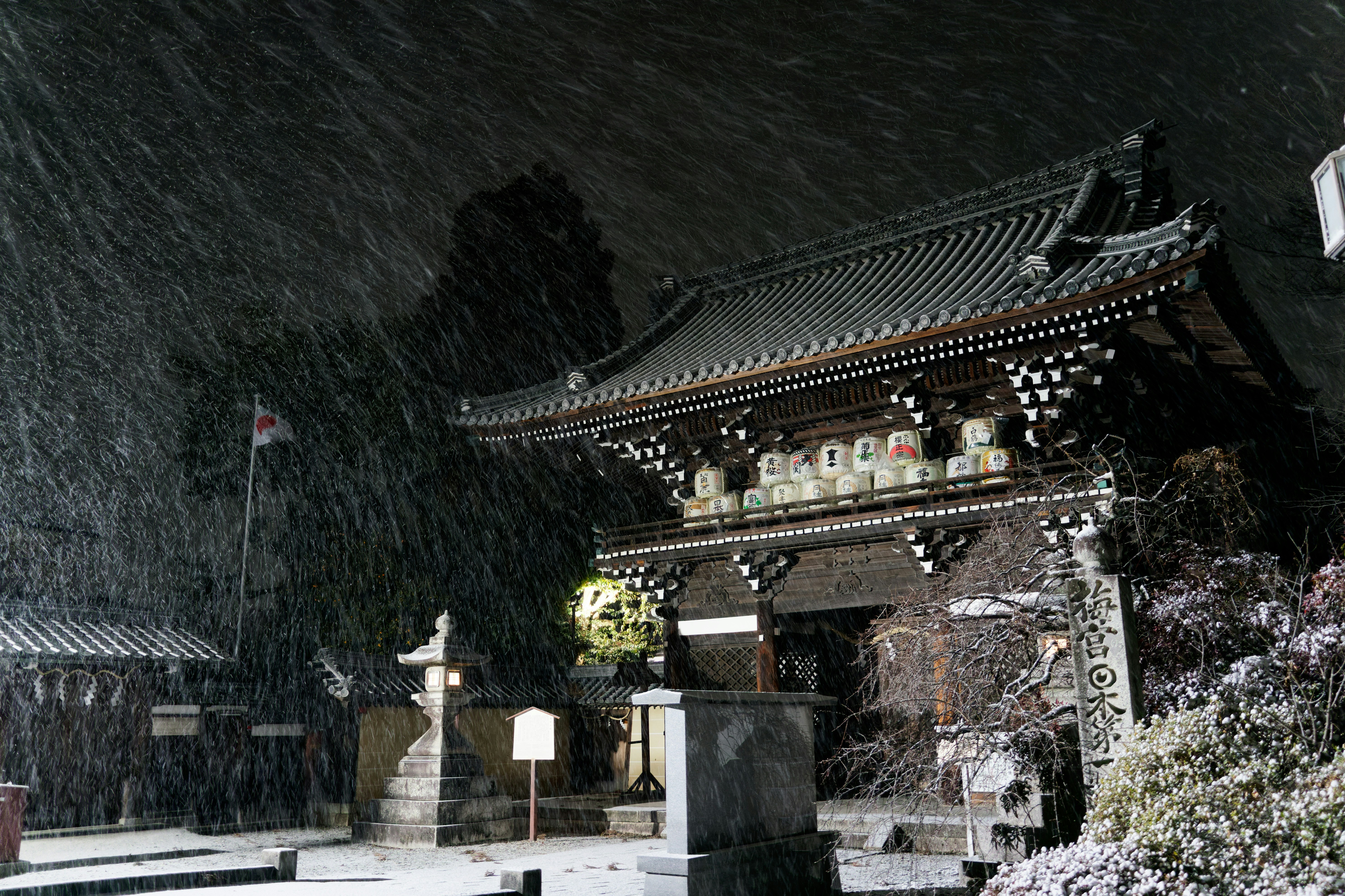 A temple stands in the snowfall at night.