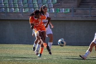 A soccer player kicks the ball during a game.