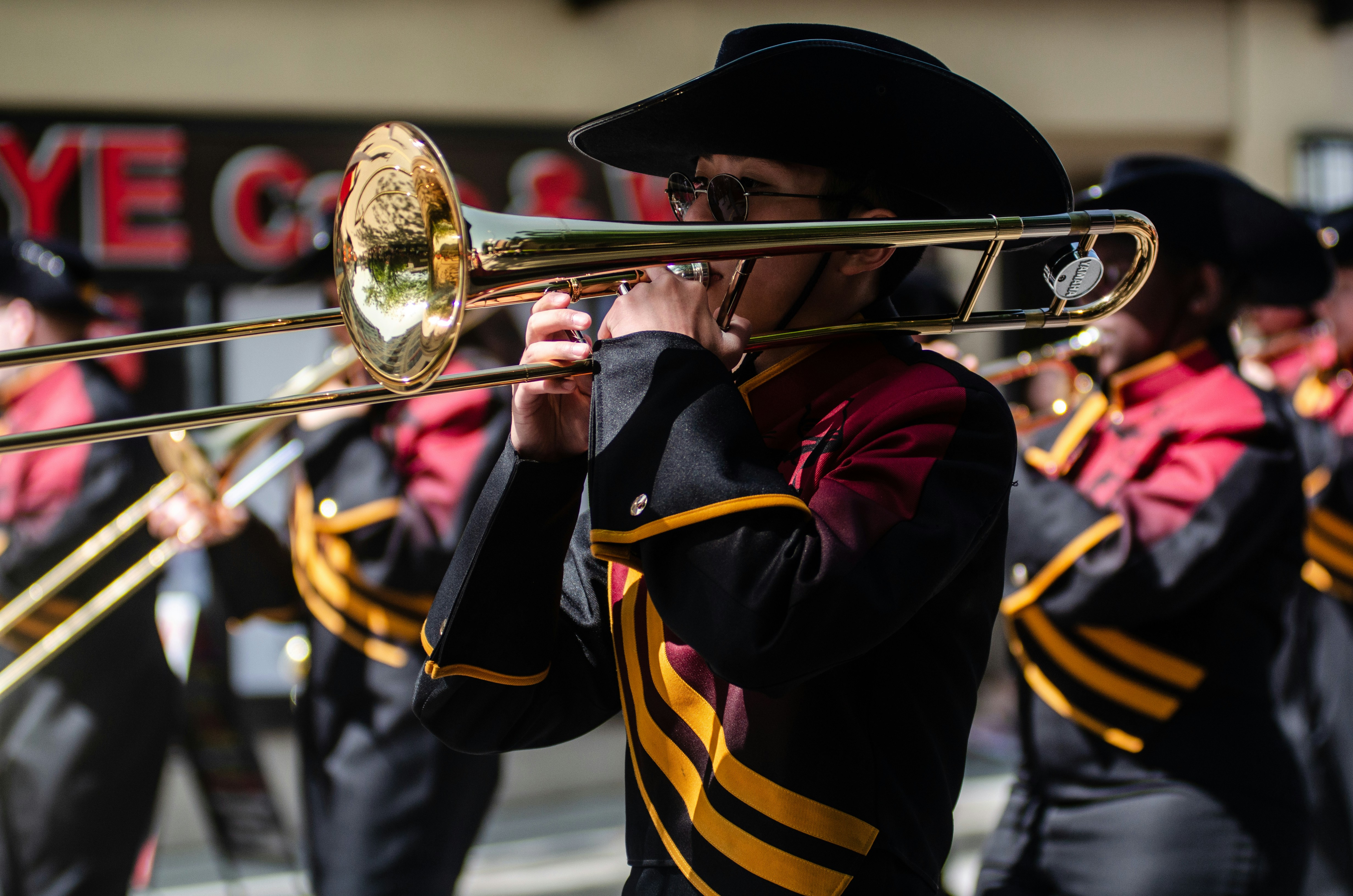 A marching band member plays the trombone.