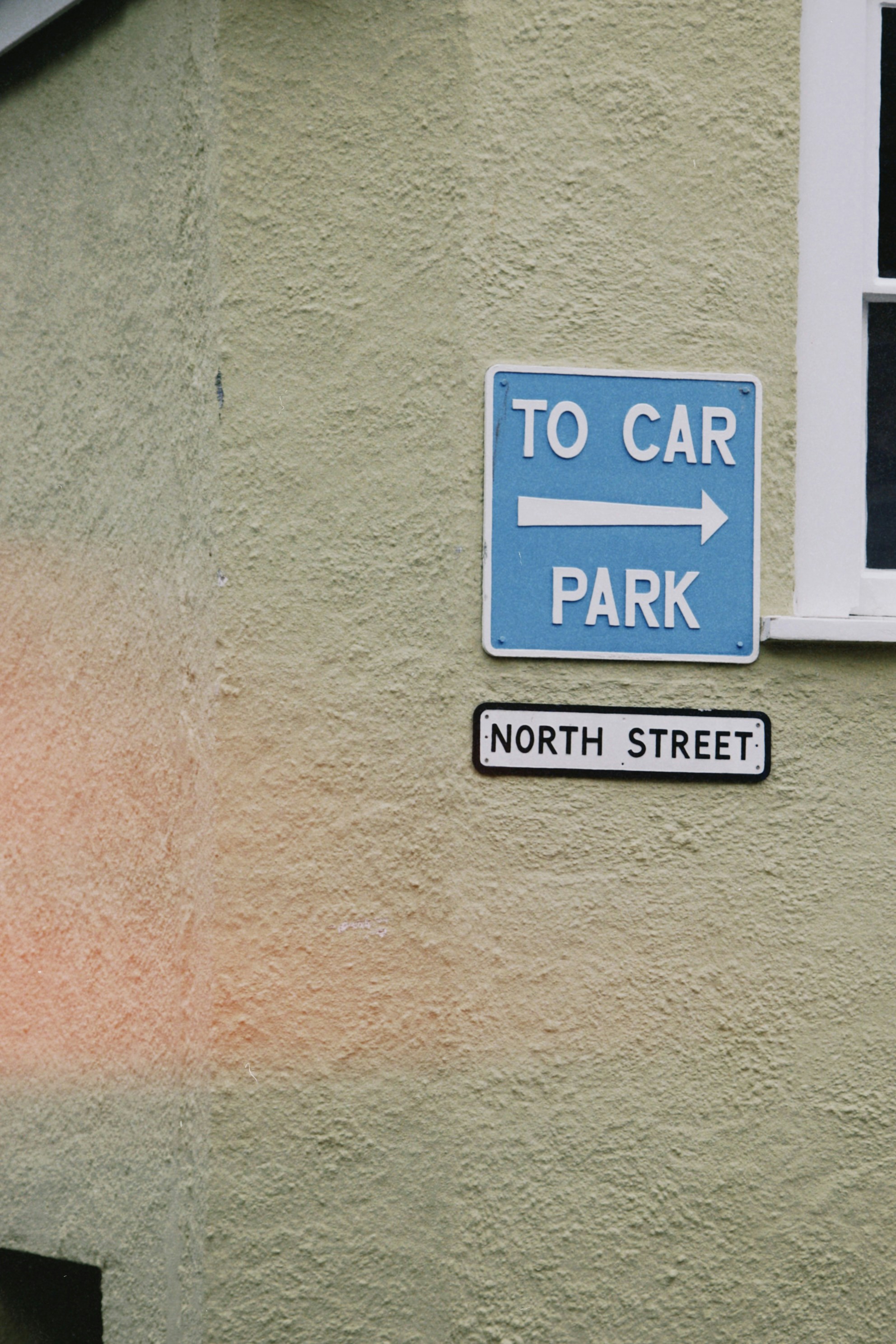 Signs indicate direction to the car park and north street.