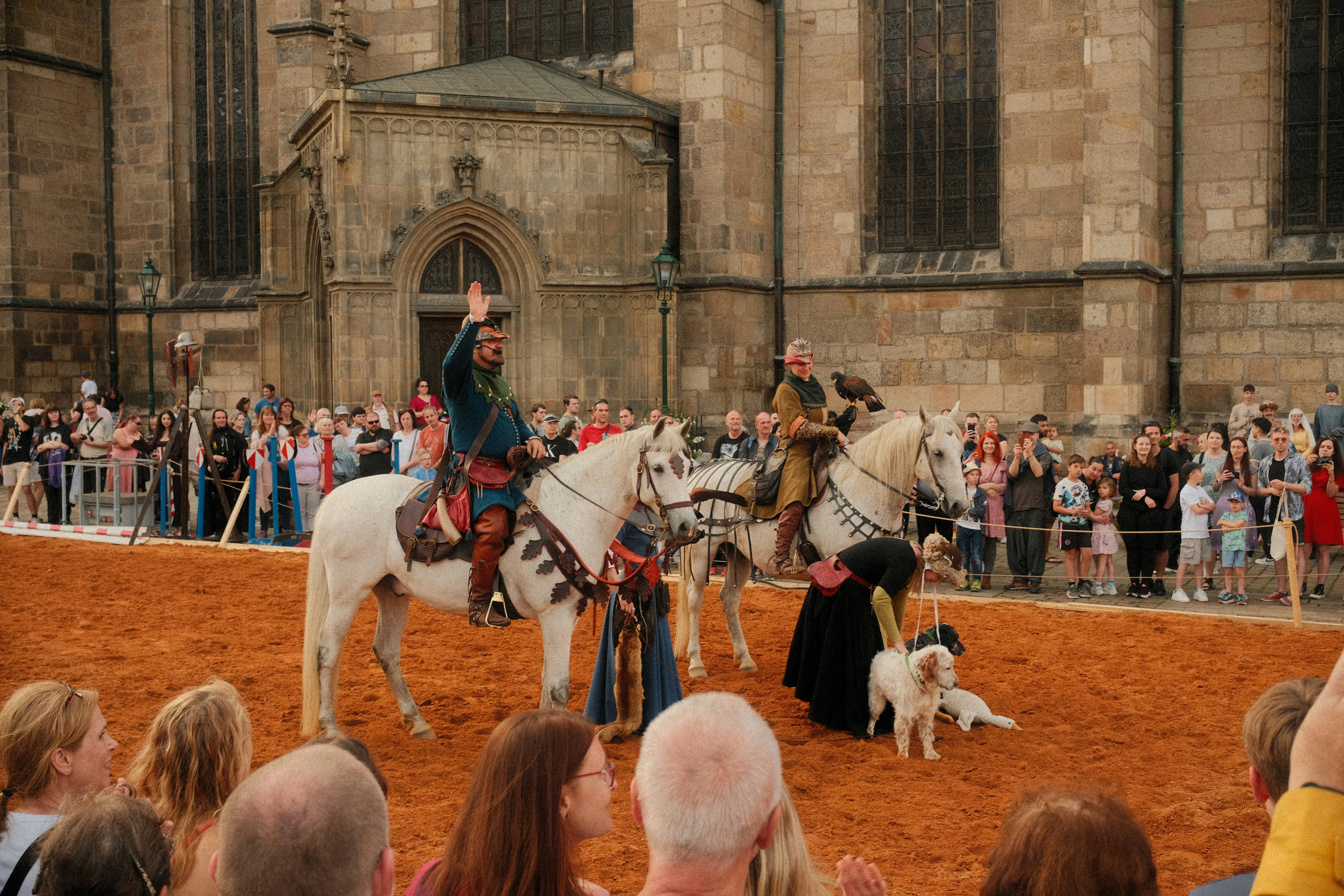 Medieval horseback riders perform for an audience.