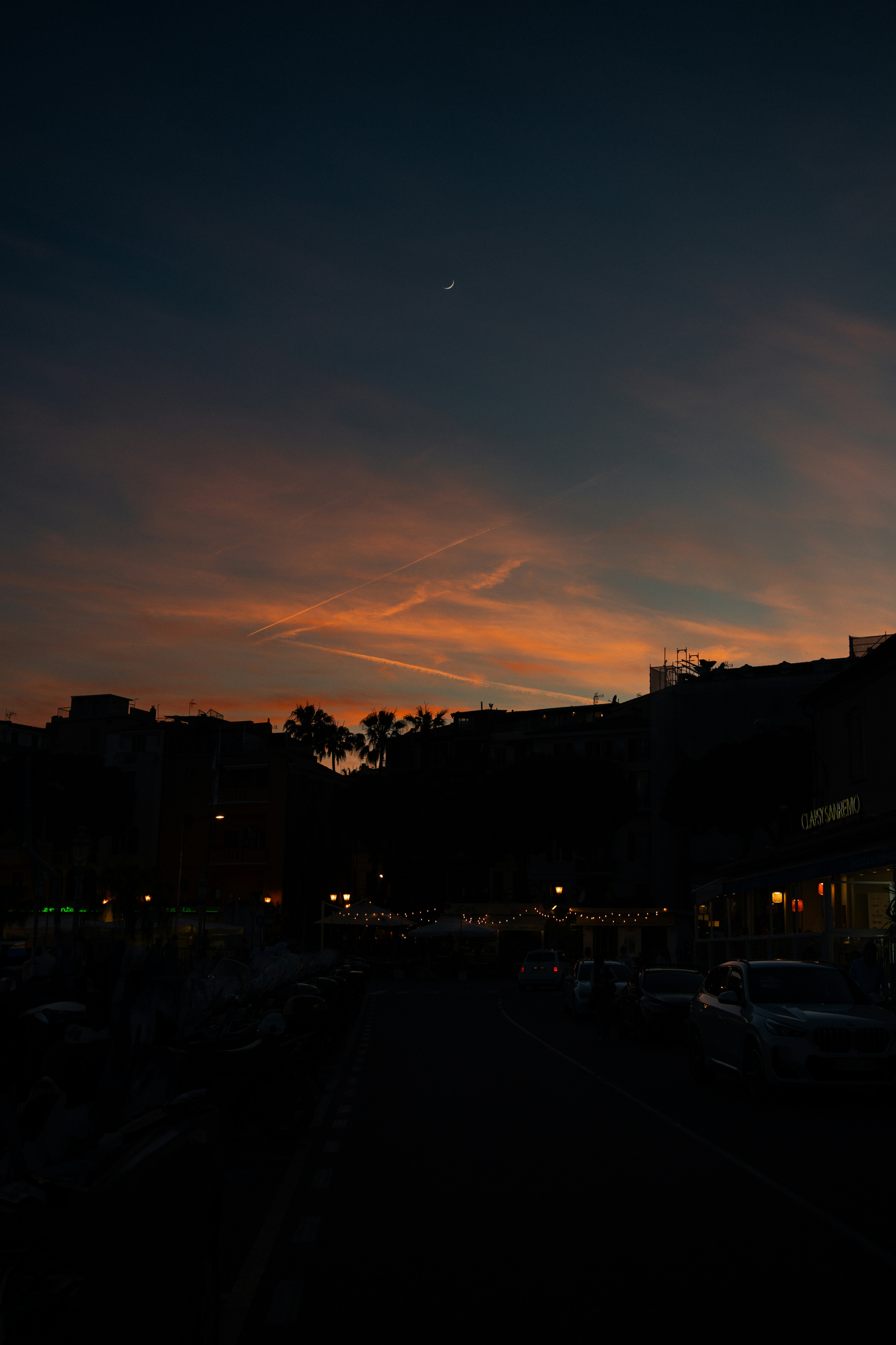 A beautiful sunset with a crescent moon.
