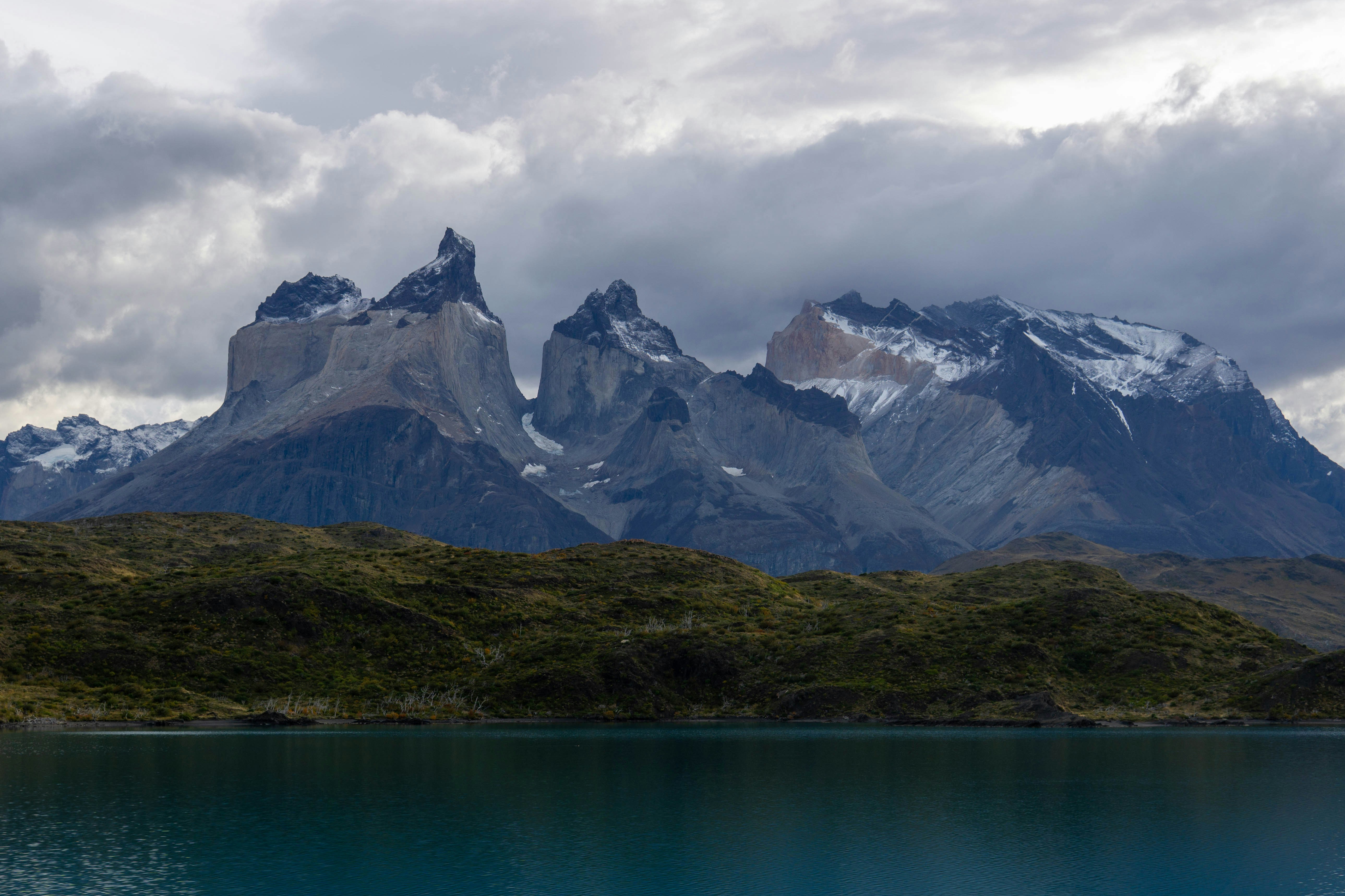 Mountains and a lake under a cloudy sky.