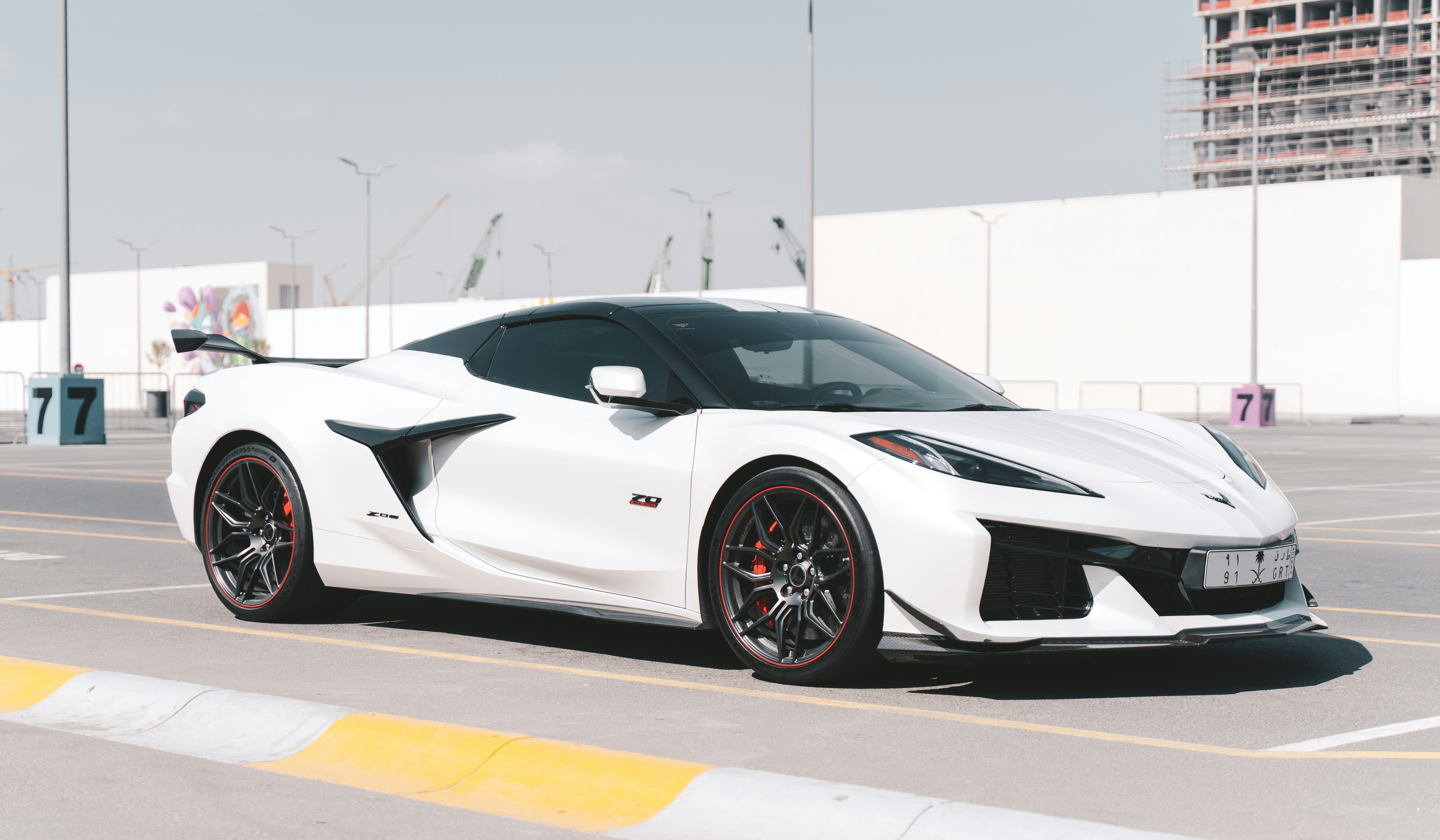 White Chevrolet Corvette Z06 with a black roof and a rear wing