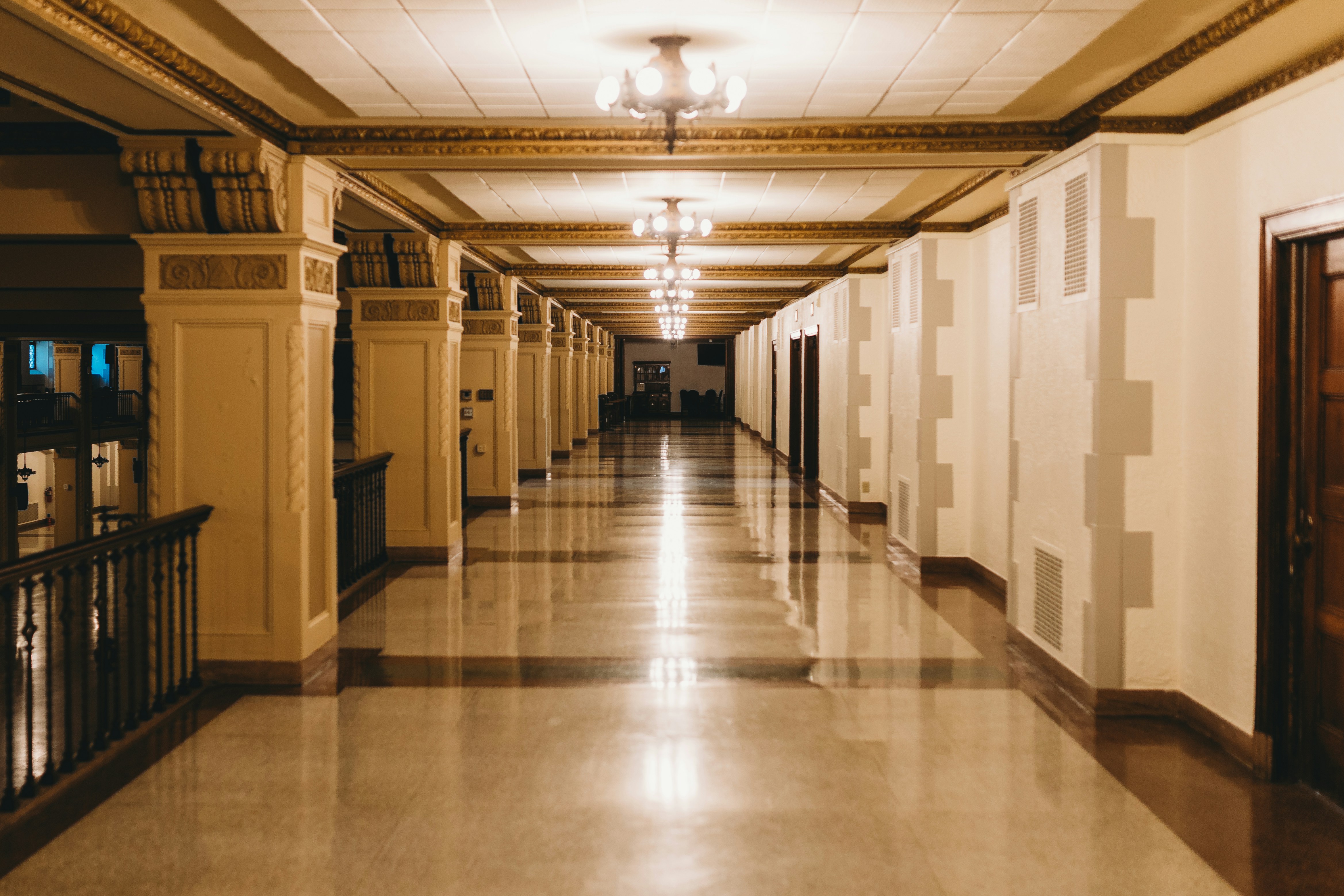 Long, elegant hallway with shiny, reflective floors.