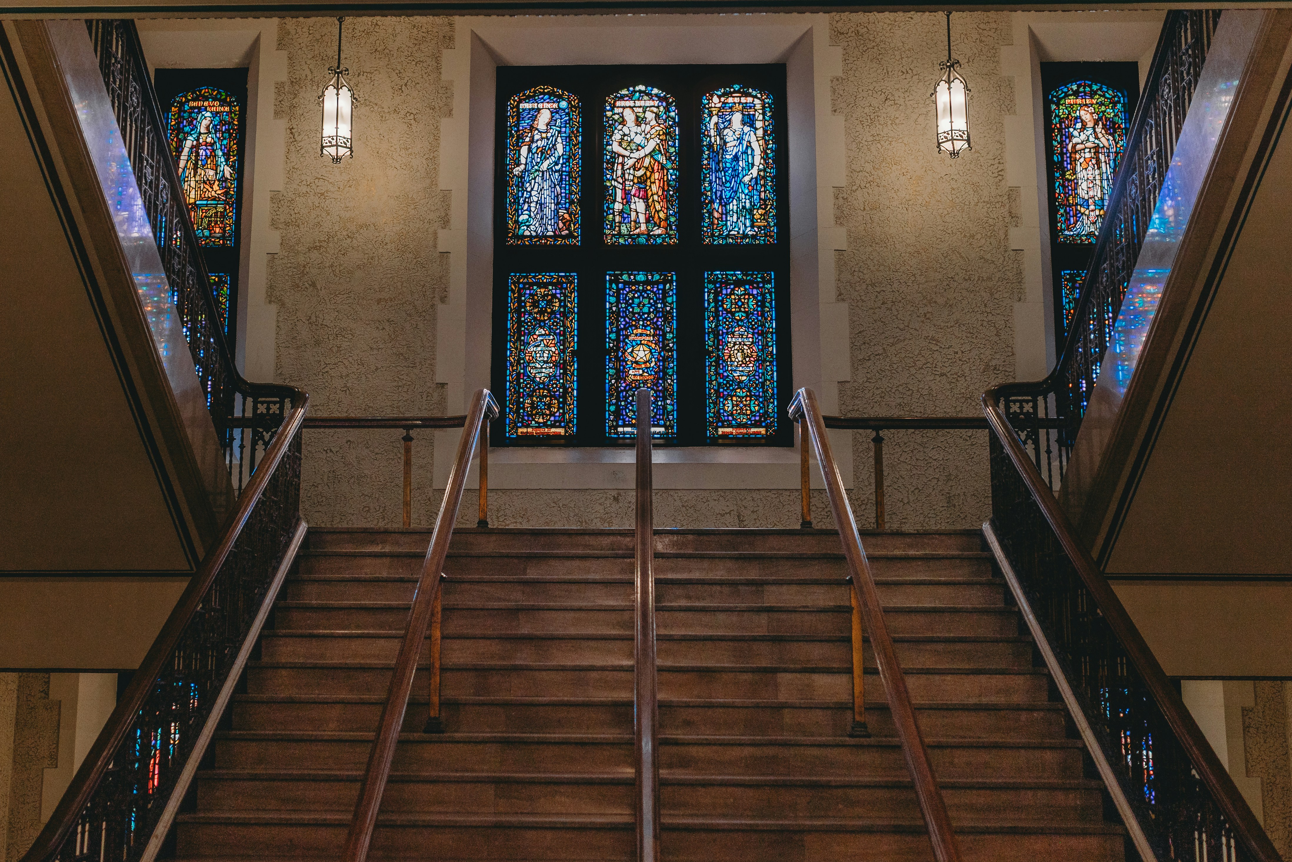 Staircase leads up to stained glass windows.