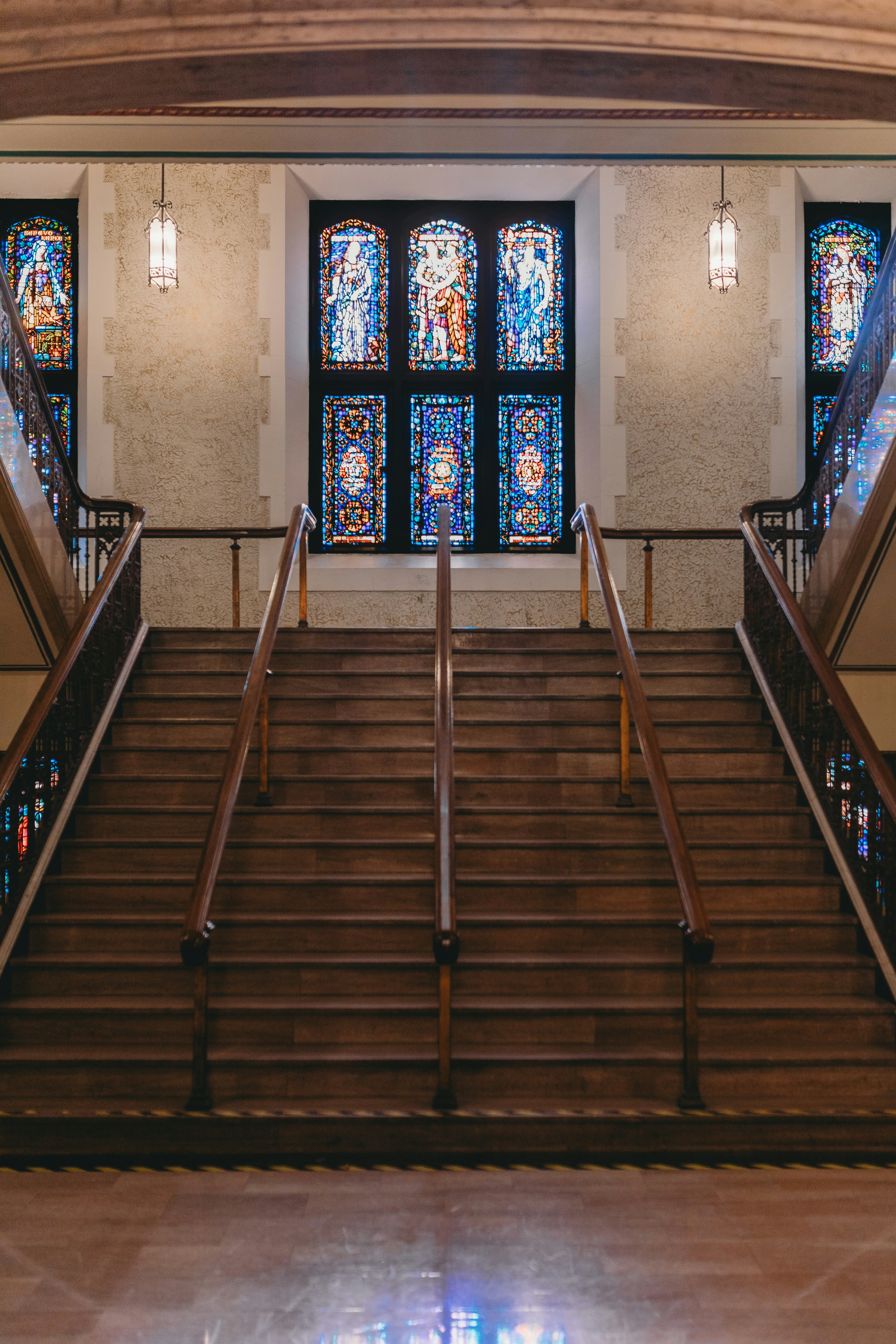 Staircase leads up to stained glass windows.