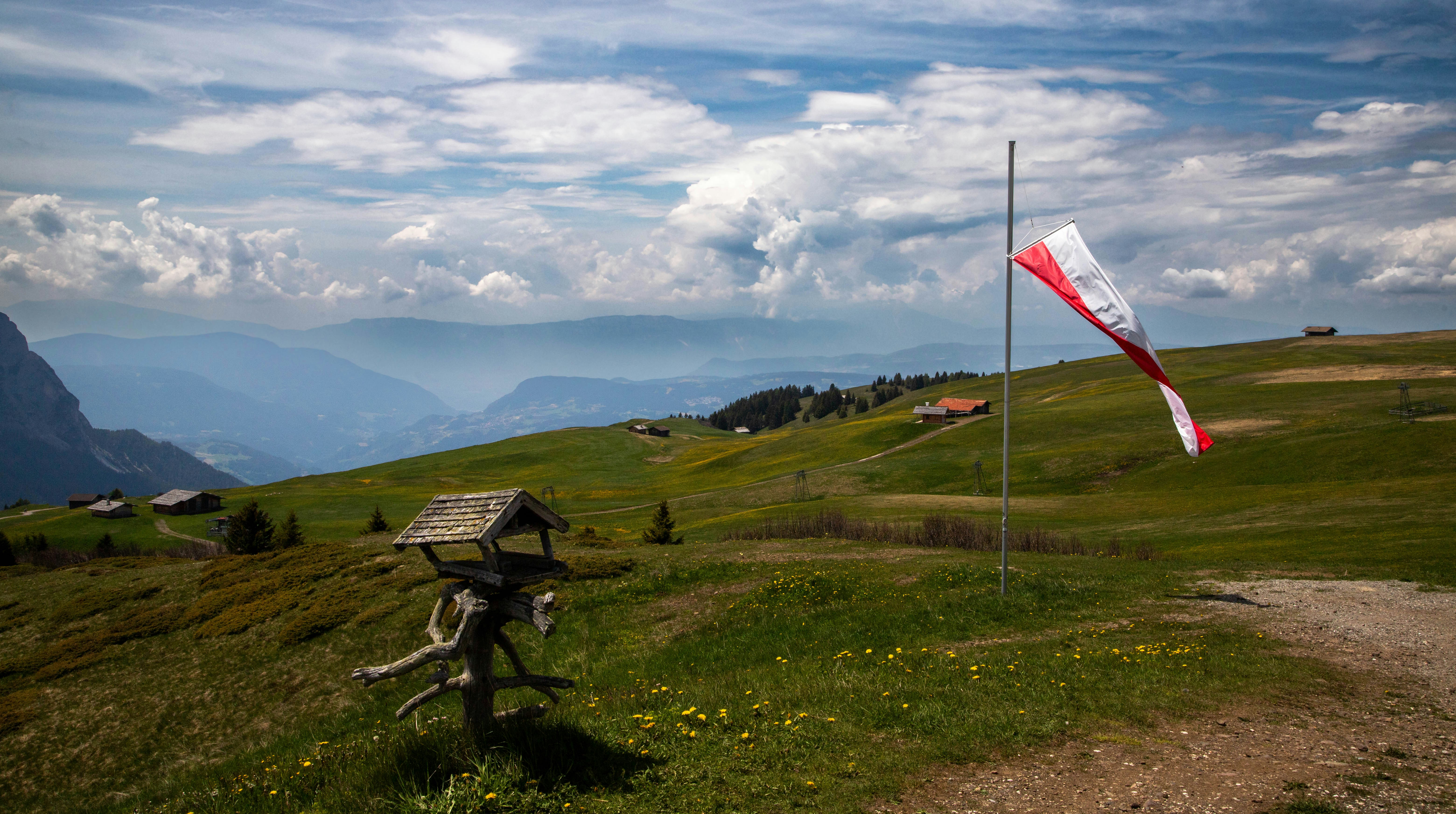 Wind sock blows on a lush, mountain landscape.