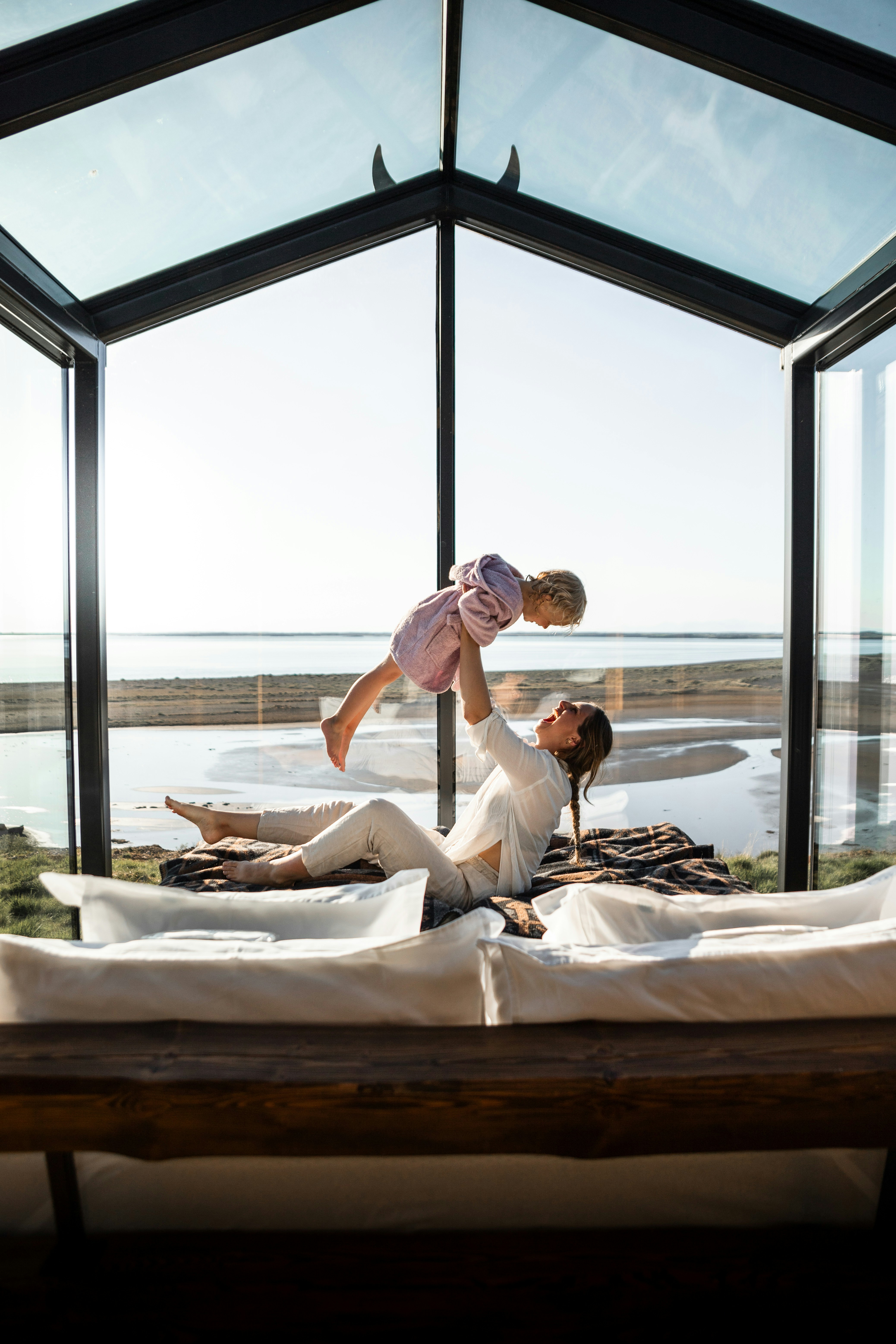 Mother lifts her daughter in a beautiful room.