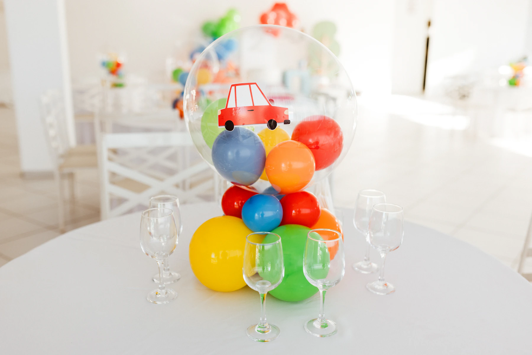 Colorful party balloons and coordinated celebration decorations arranged around a styled table