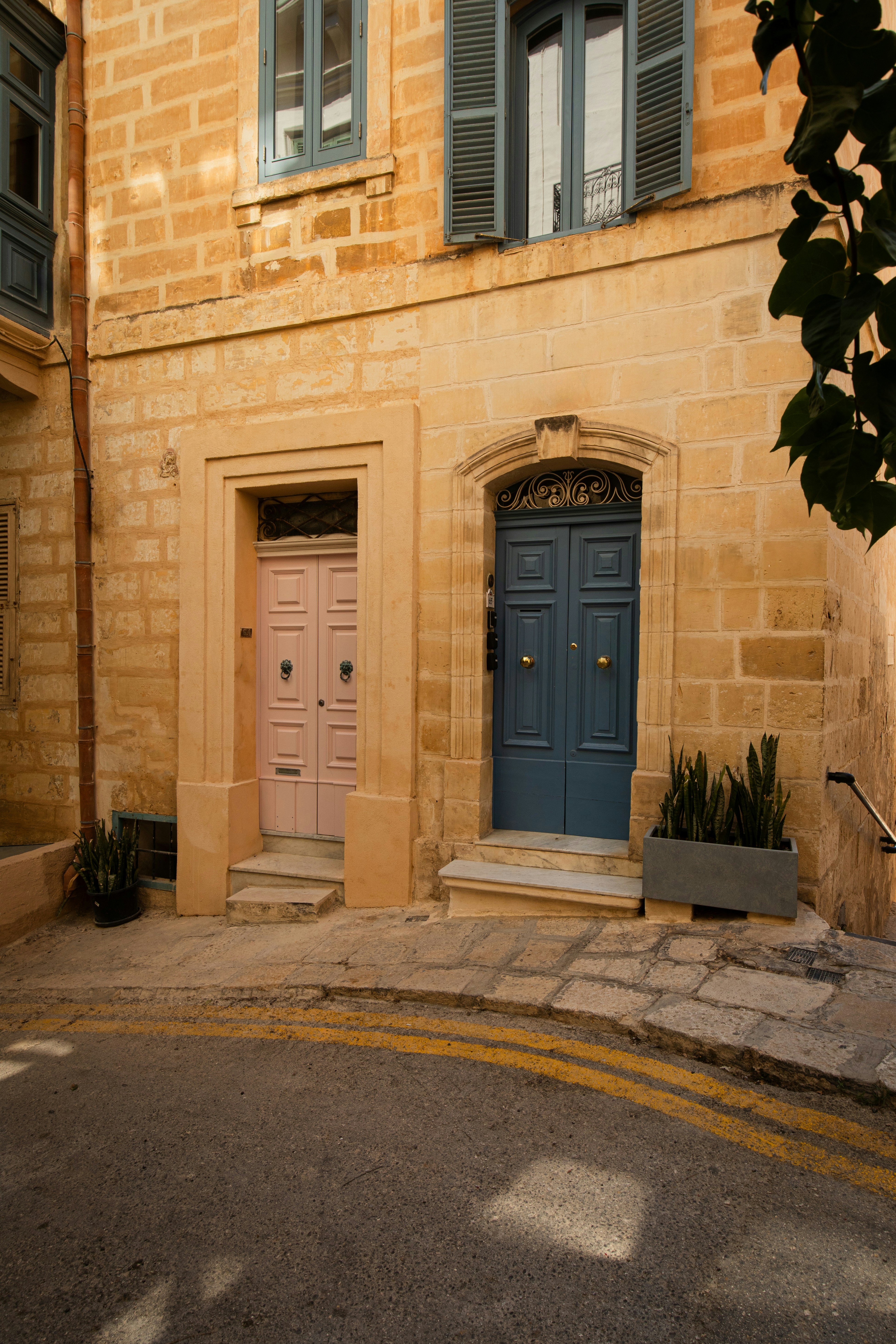 Two colorful doors on a charming old building.