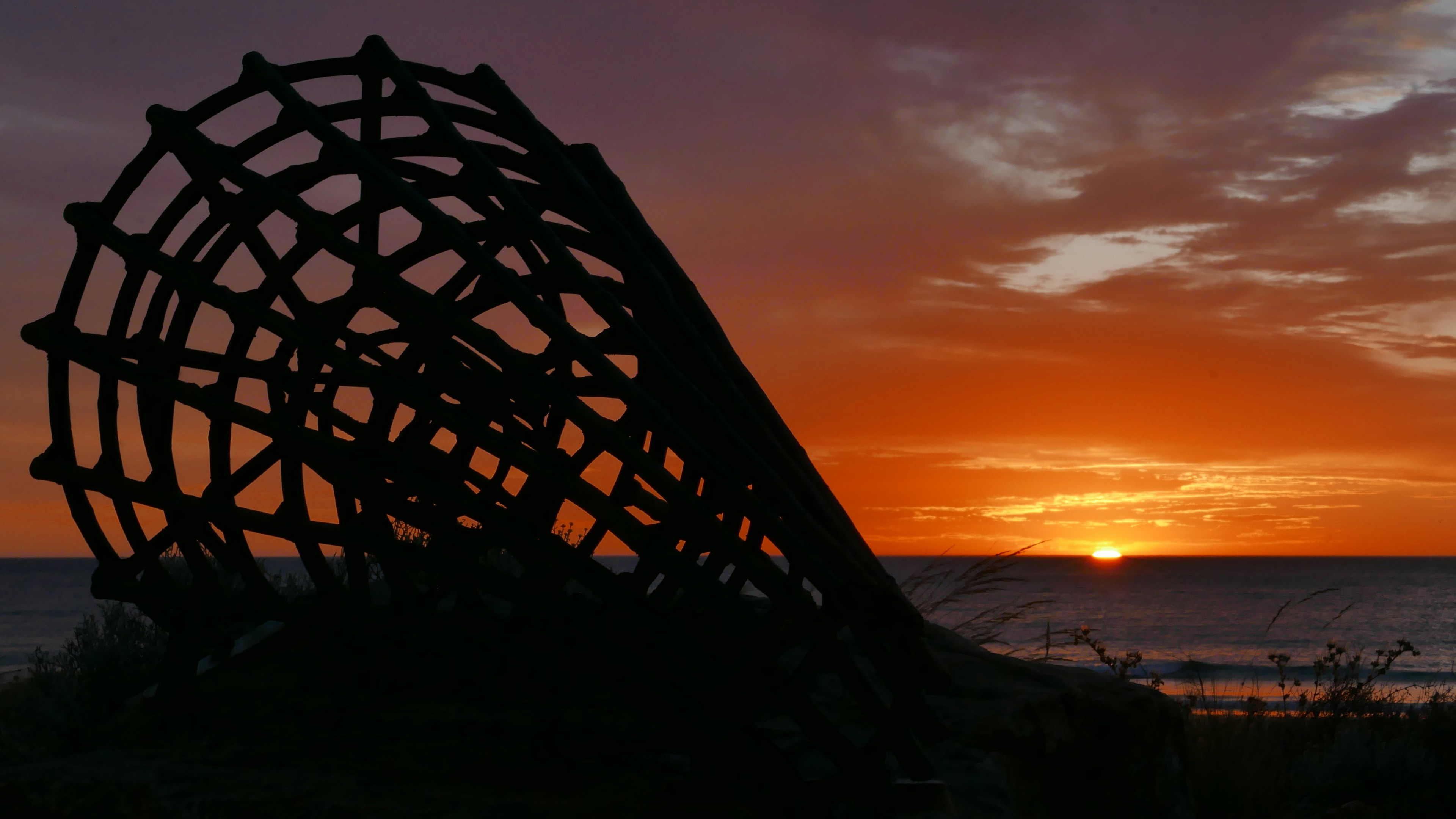 Silhouette sculpture against a beautiful sunset sky.