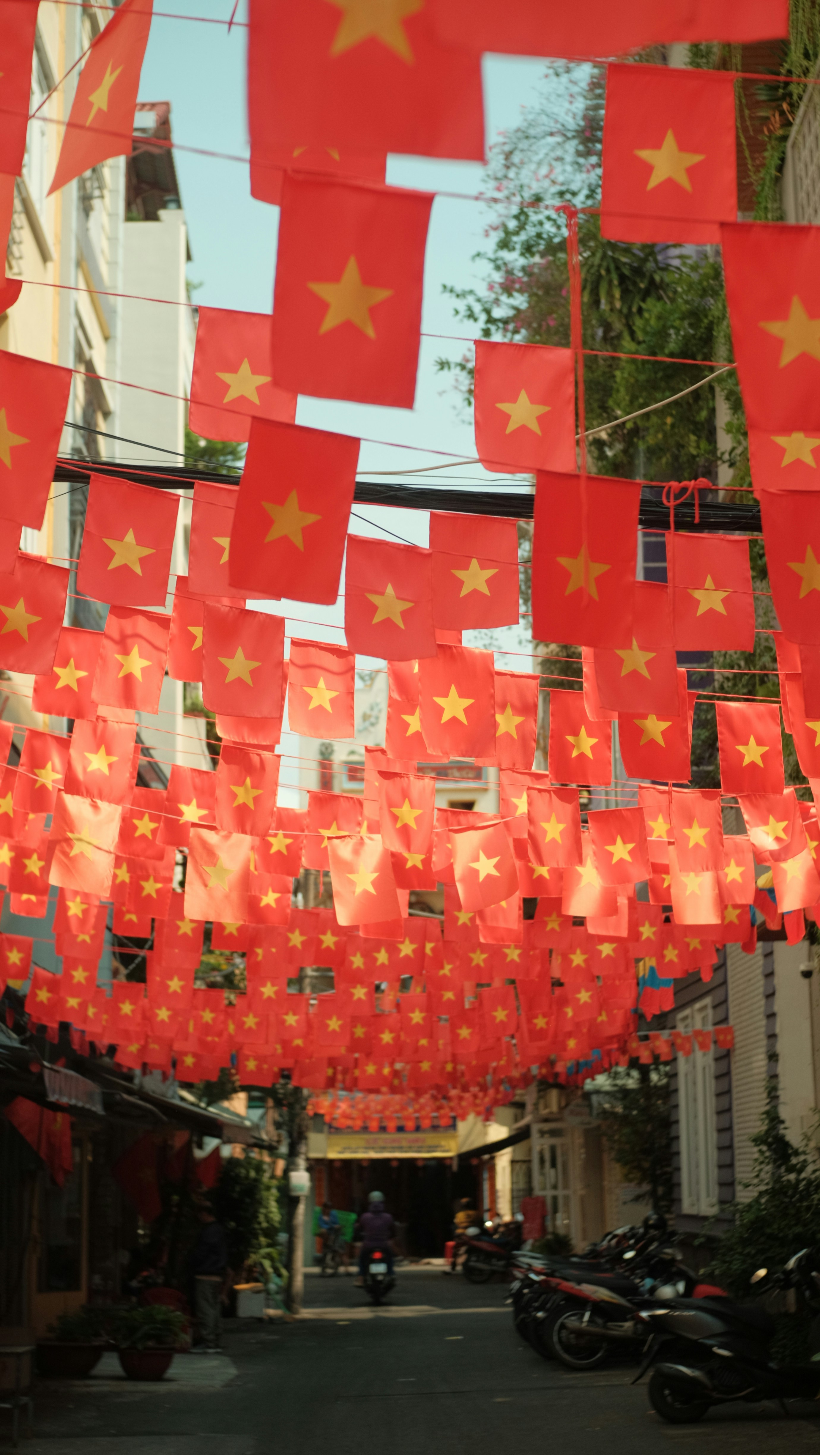 Vietnamese flags decorate a street overhead.