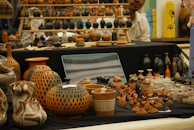 Pottery and ceramic art displayed on a table.