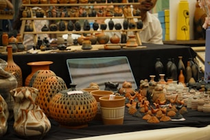 Pottery and ceramic art displayed on a table.