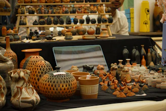 Pottery and ceramic art displayed on a table.