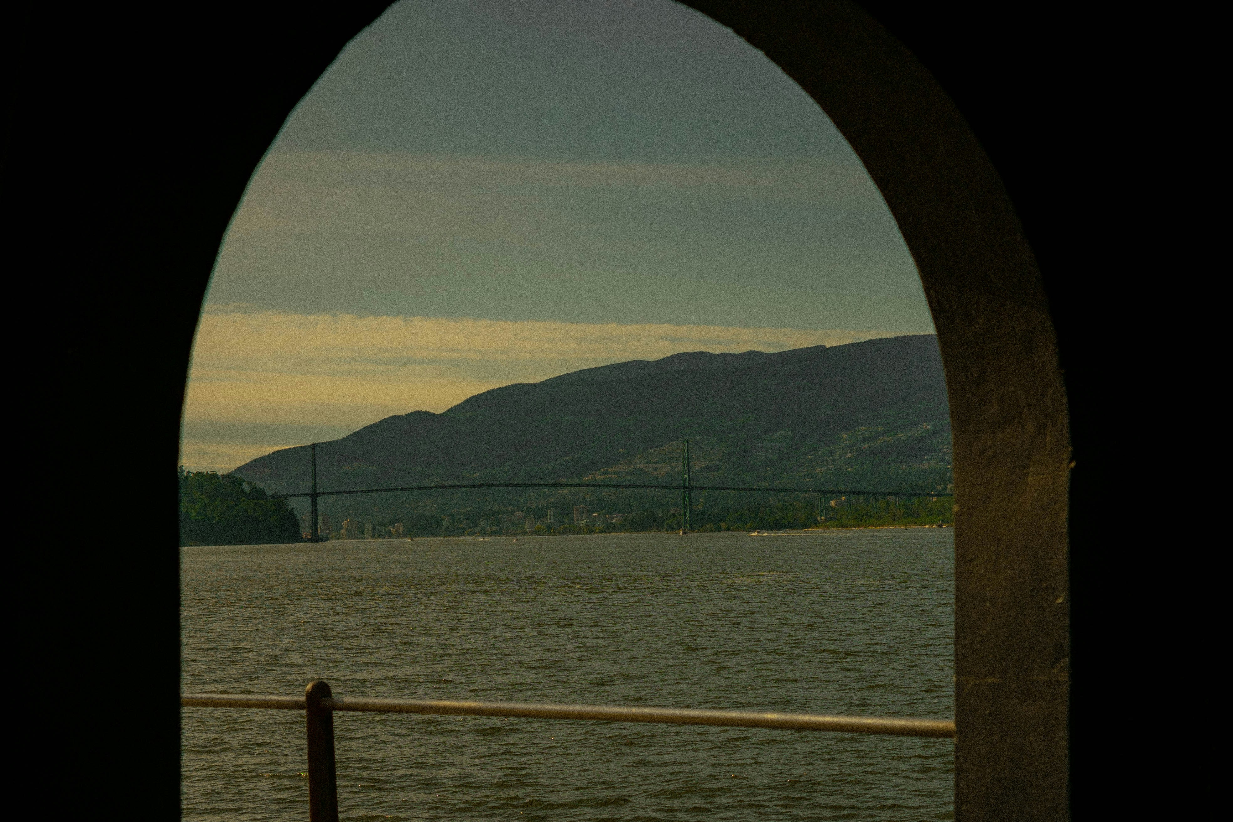 View of the bridge and mountain through an arch.