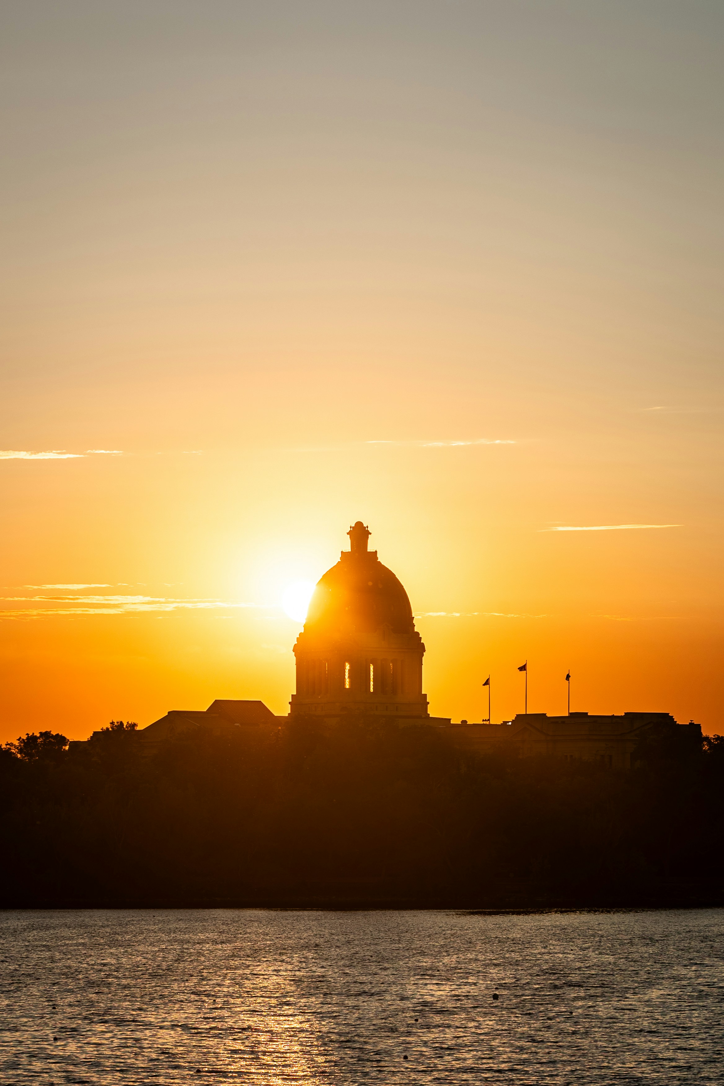 Silhouette of building against a vibrant sunset.