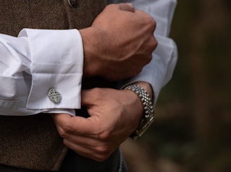 Man adjusts his cuff links.
