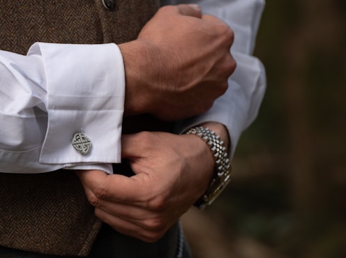 Man adjusts his cuff links.