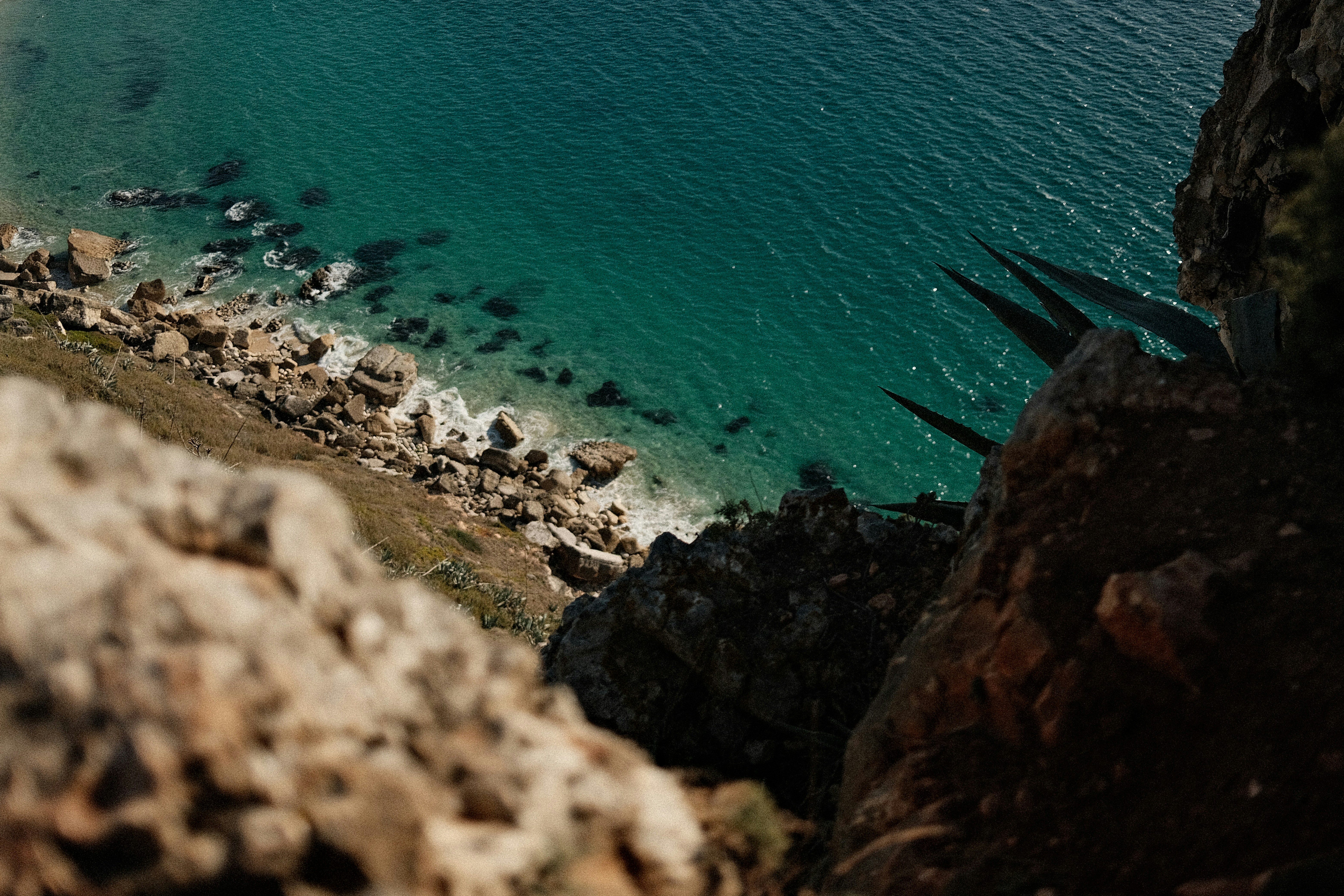 Cliffside view of the ocean and shoreline.