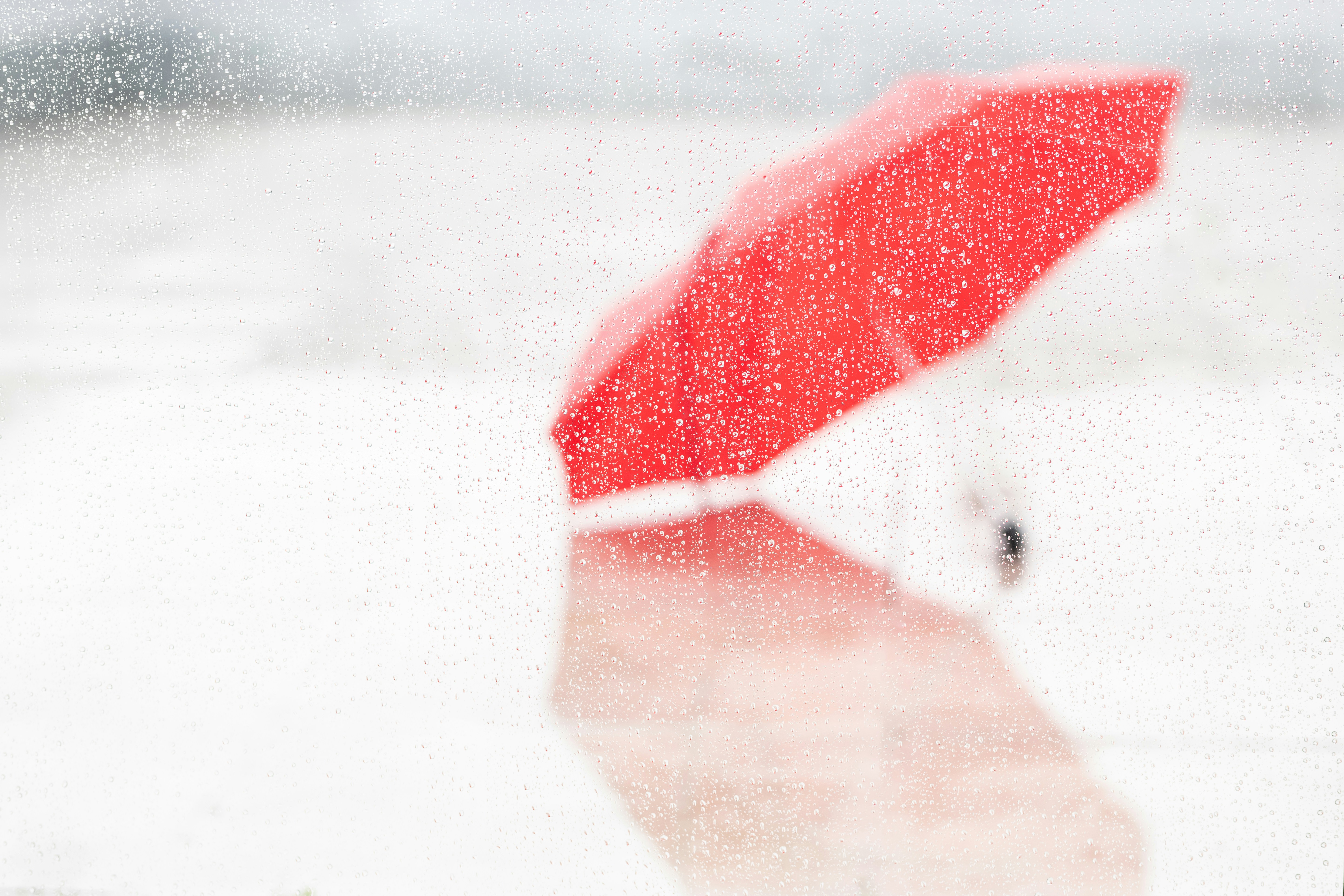 A red umbrella in heavy rain.