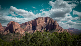 Majestic mountain under a vibrant, cloudy sky.