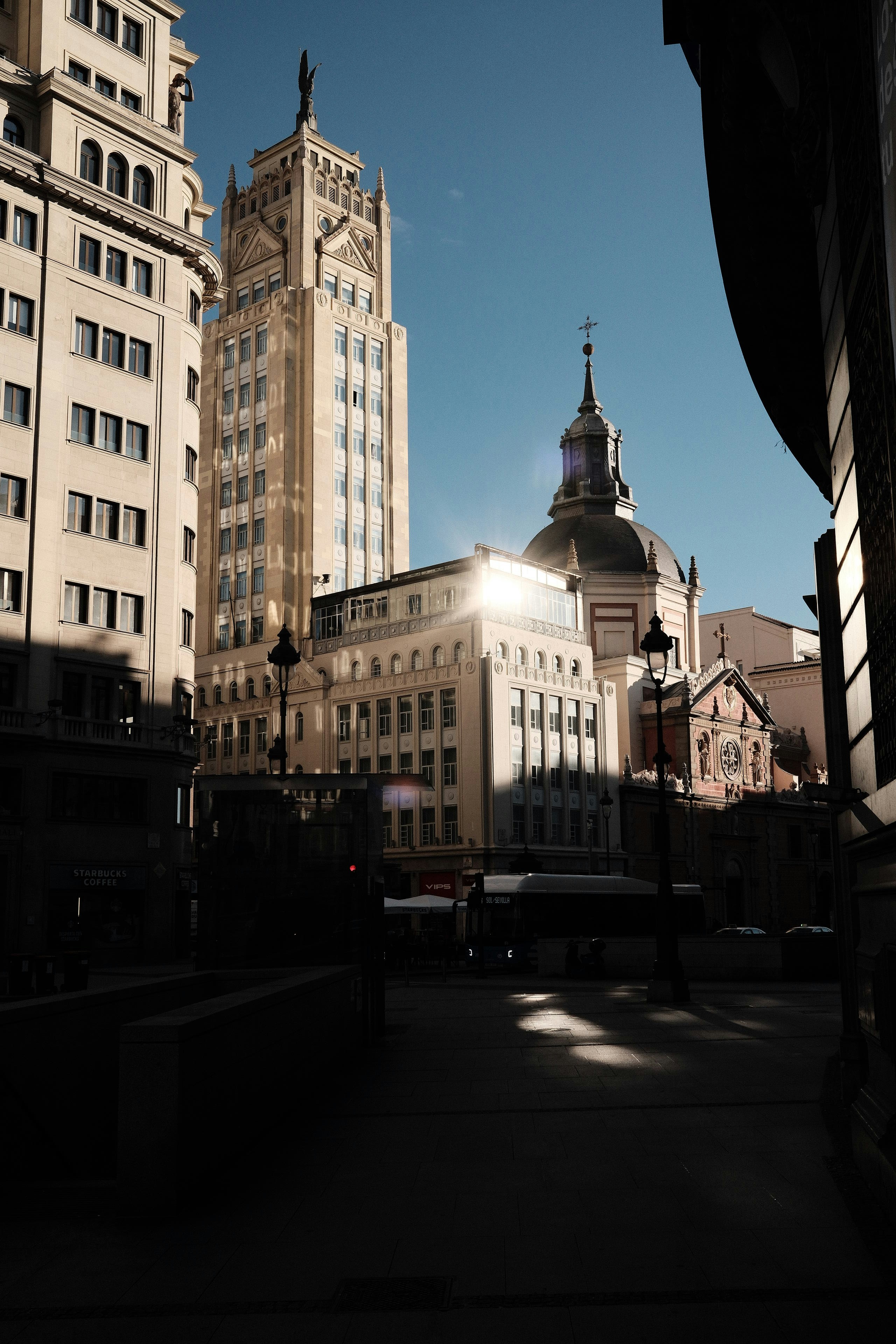 Buildings bask in sunlight on a bright day.