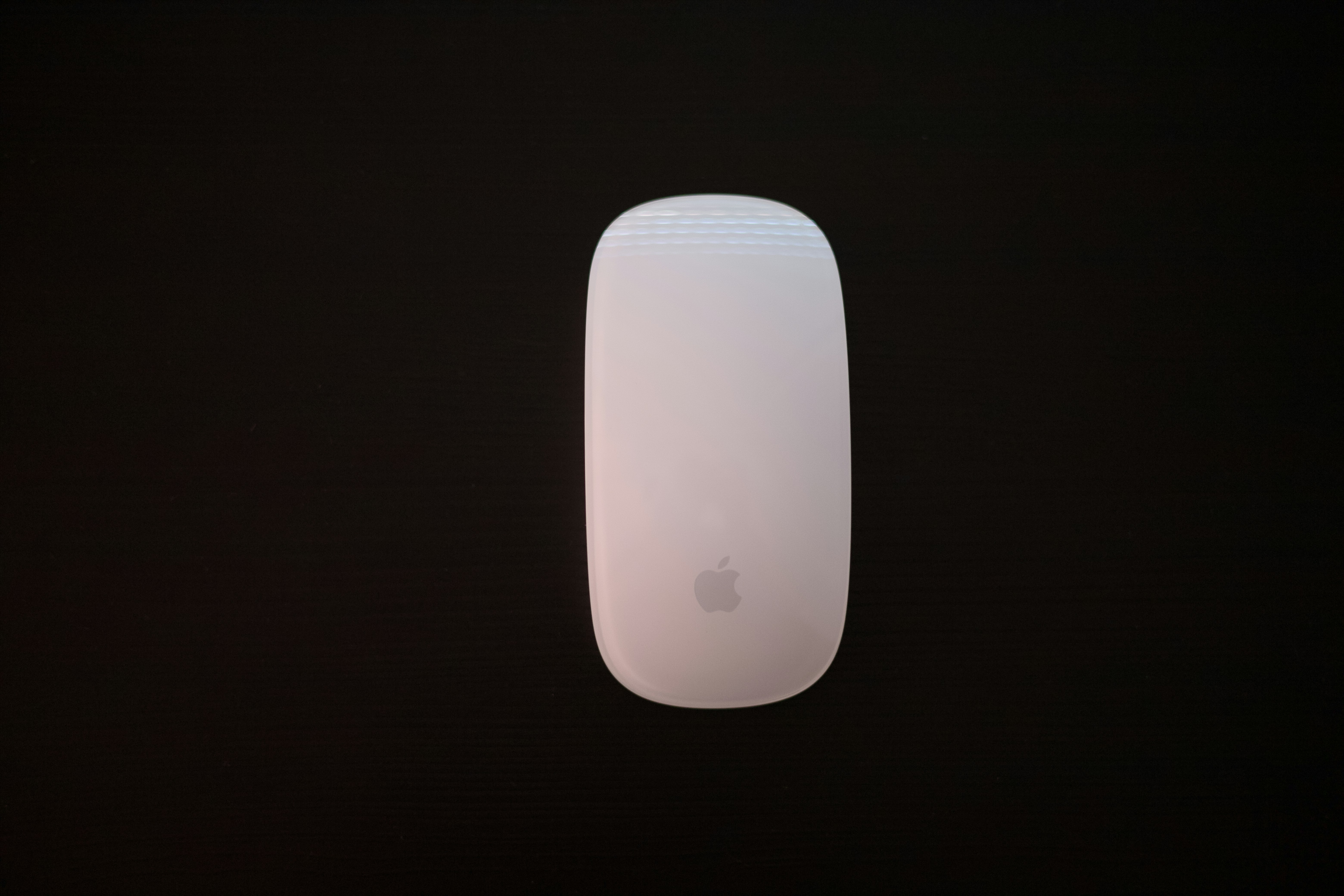 Apple mouse on a dark background.