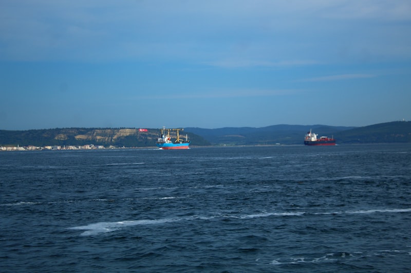 Two ships sail on a calm ocean