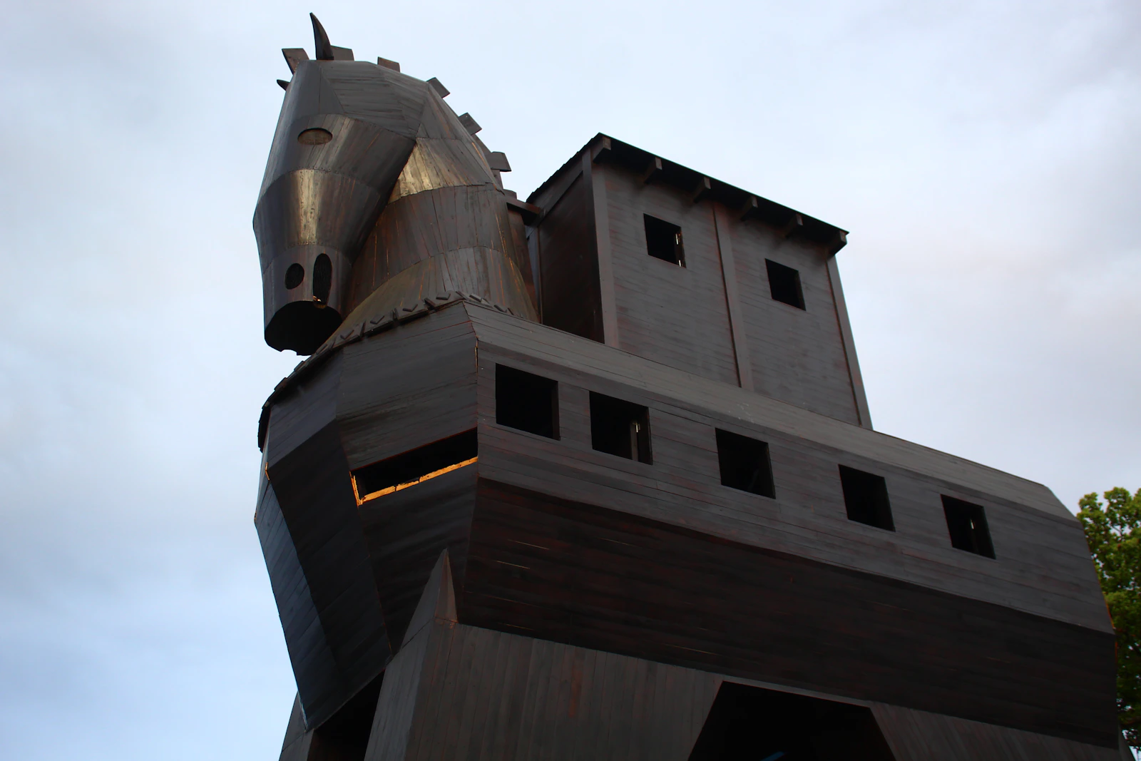 A giant wooden Trojan horse standing outdoors — the gift you wheel through your own gates, the way a poisoned error report walks straight into your coding agent.
