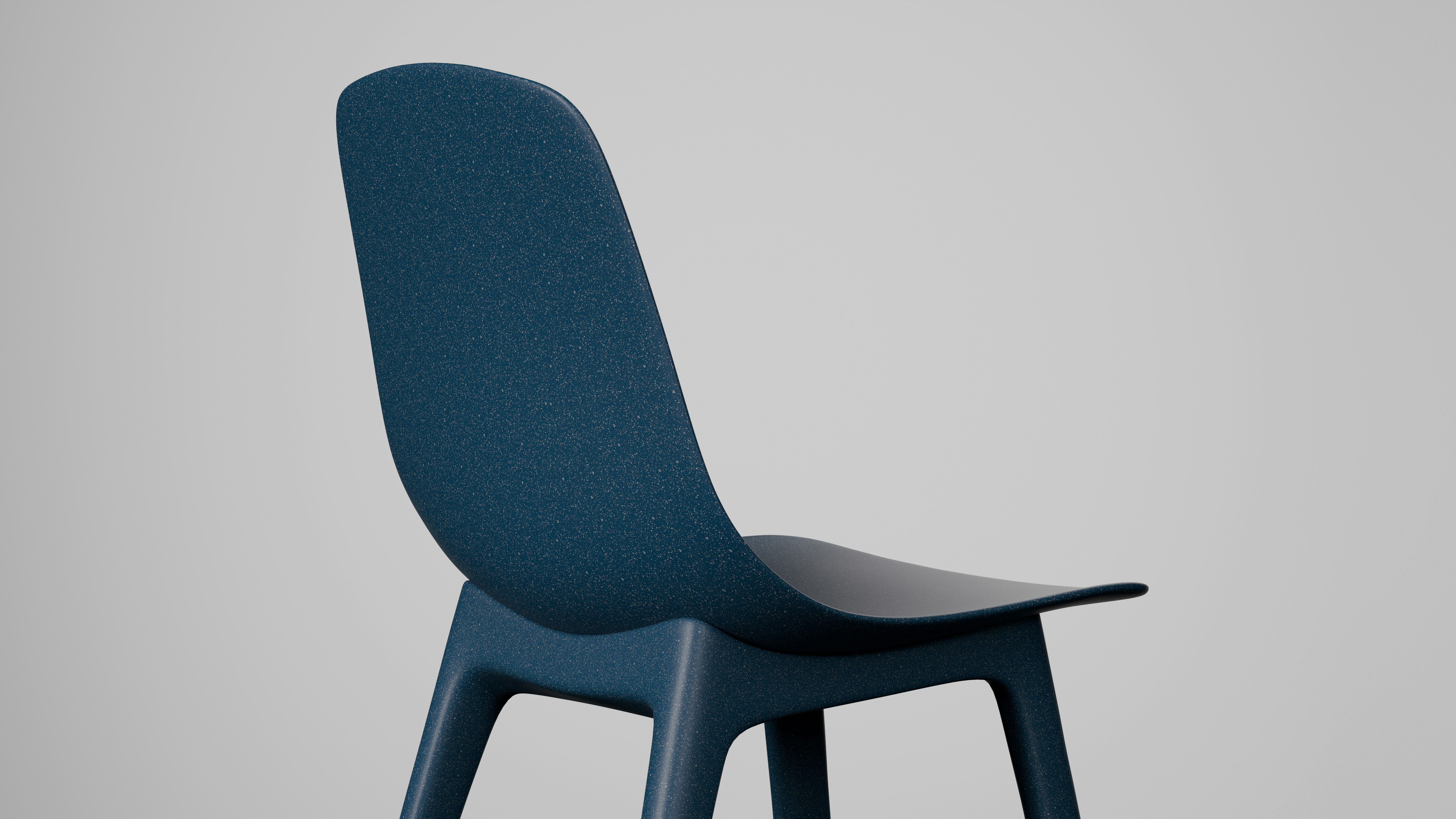 A modern dark blue dining chair with an interesting textured surface, standing firm with a minimalist design. Ideal for a contemporary dining space or as an accent chair in a workspace. Made from recycled materials, showcasing a commitment to sustainability.