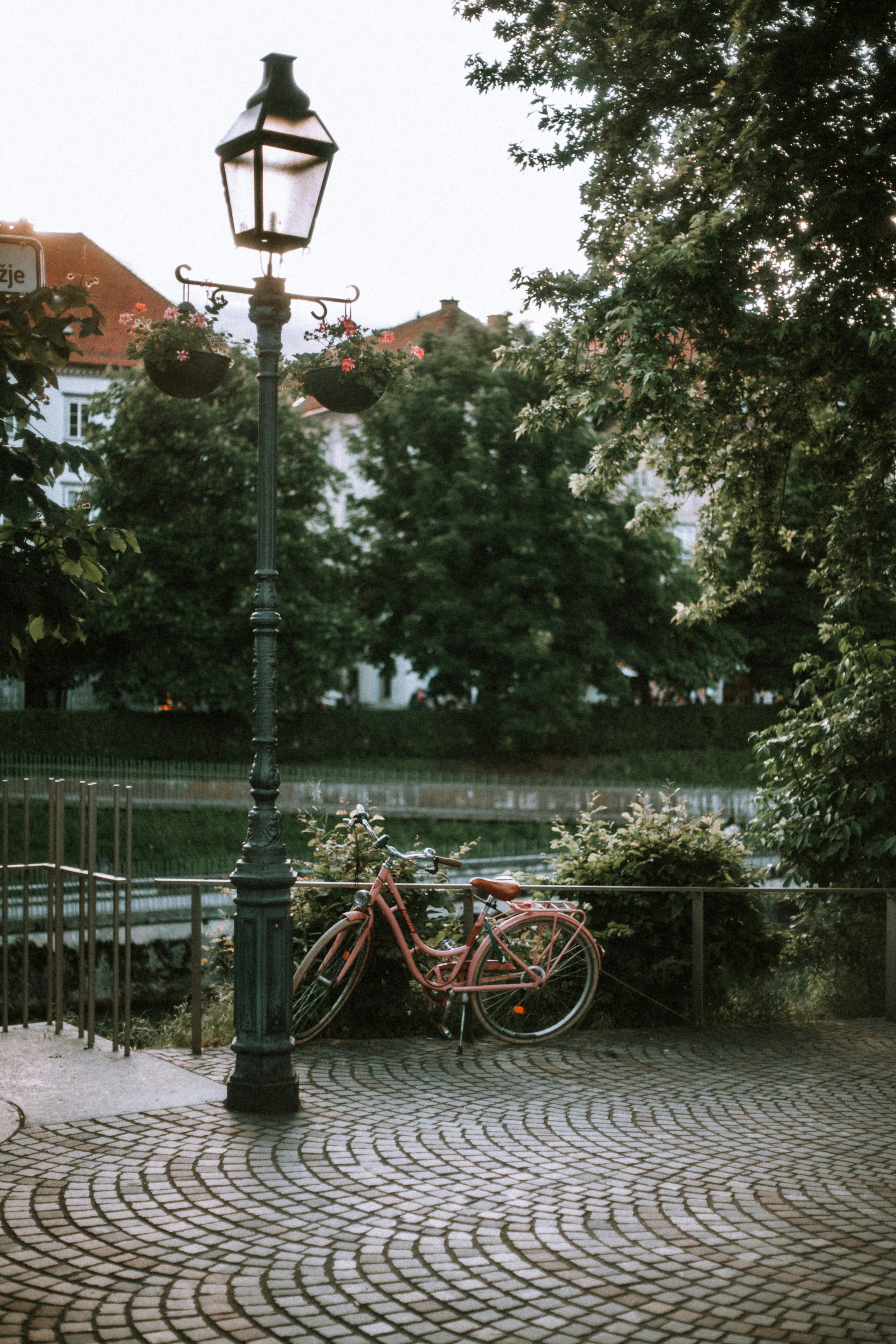 A bicycle rests beside a decorative lamp post.