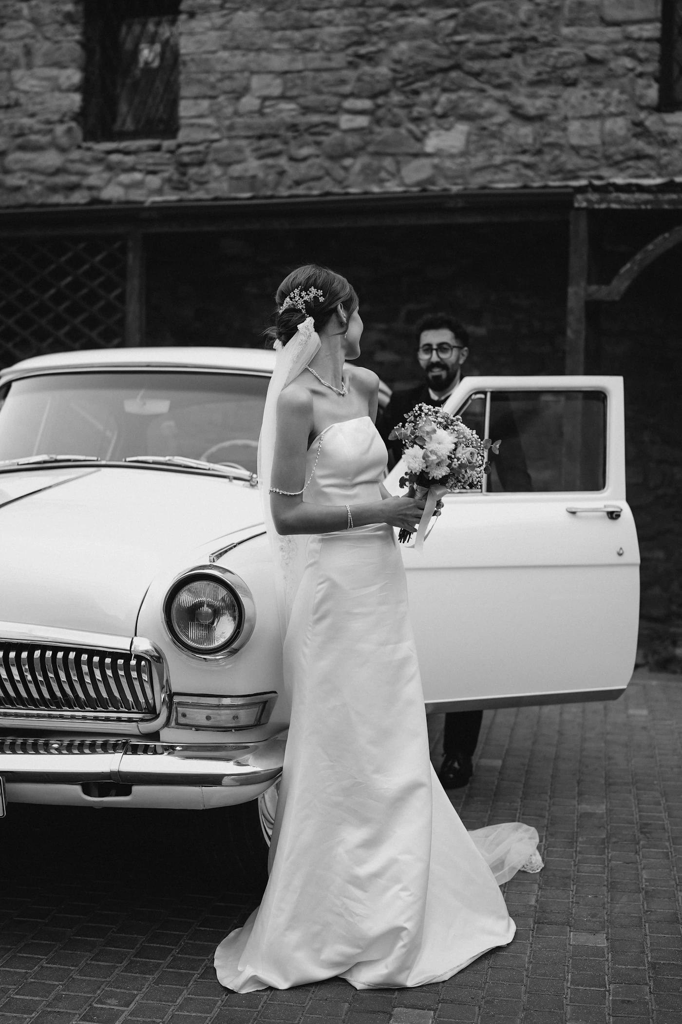 Wedding transportation options for large bridal parties — A bridal party posing by a decorated party bus for wedding photos