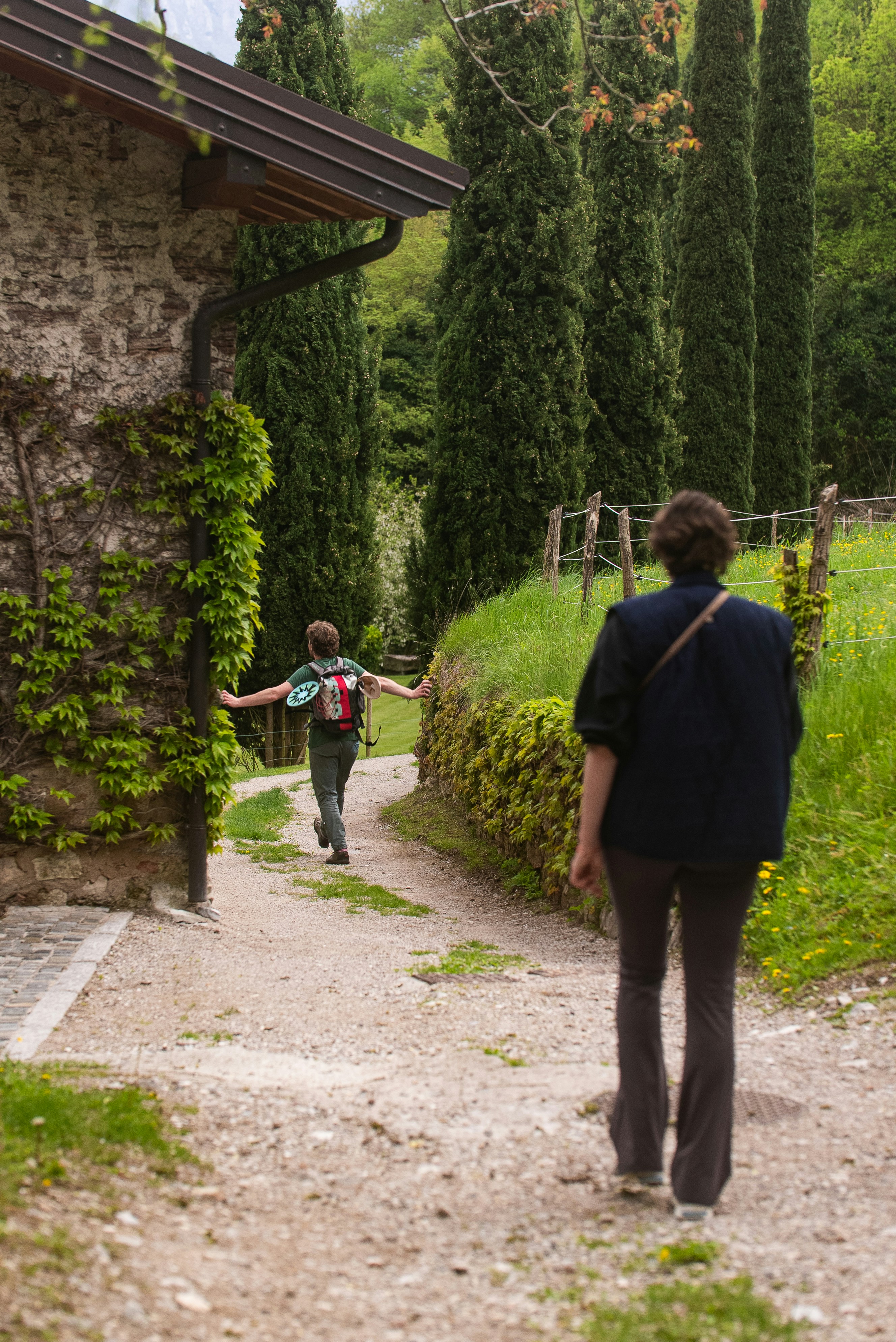 People walk down a path in a beautiful setting.