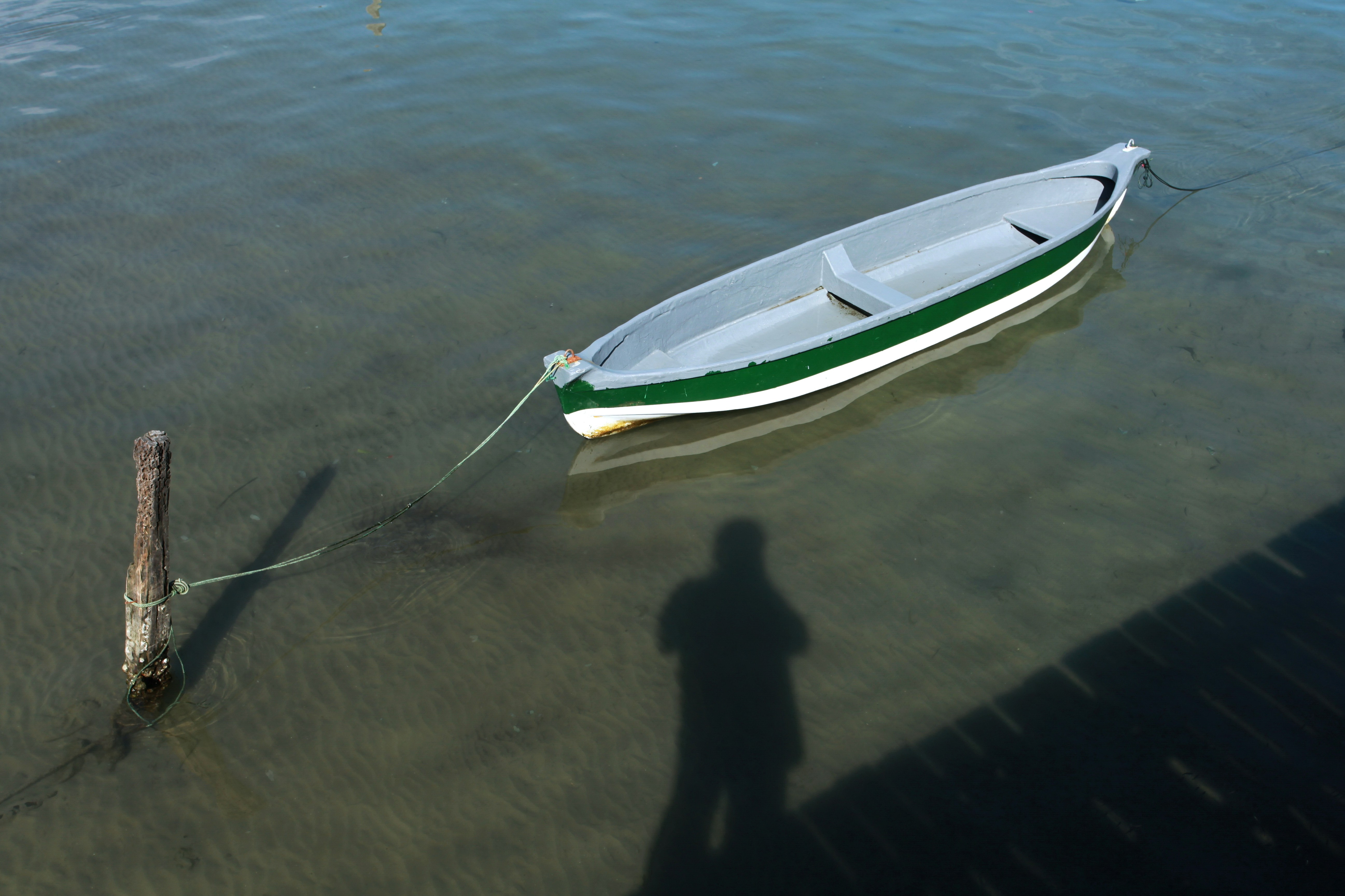 A boat rests in the shallow water.
