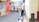 Woman walks down a colorful street in a city.