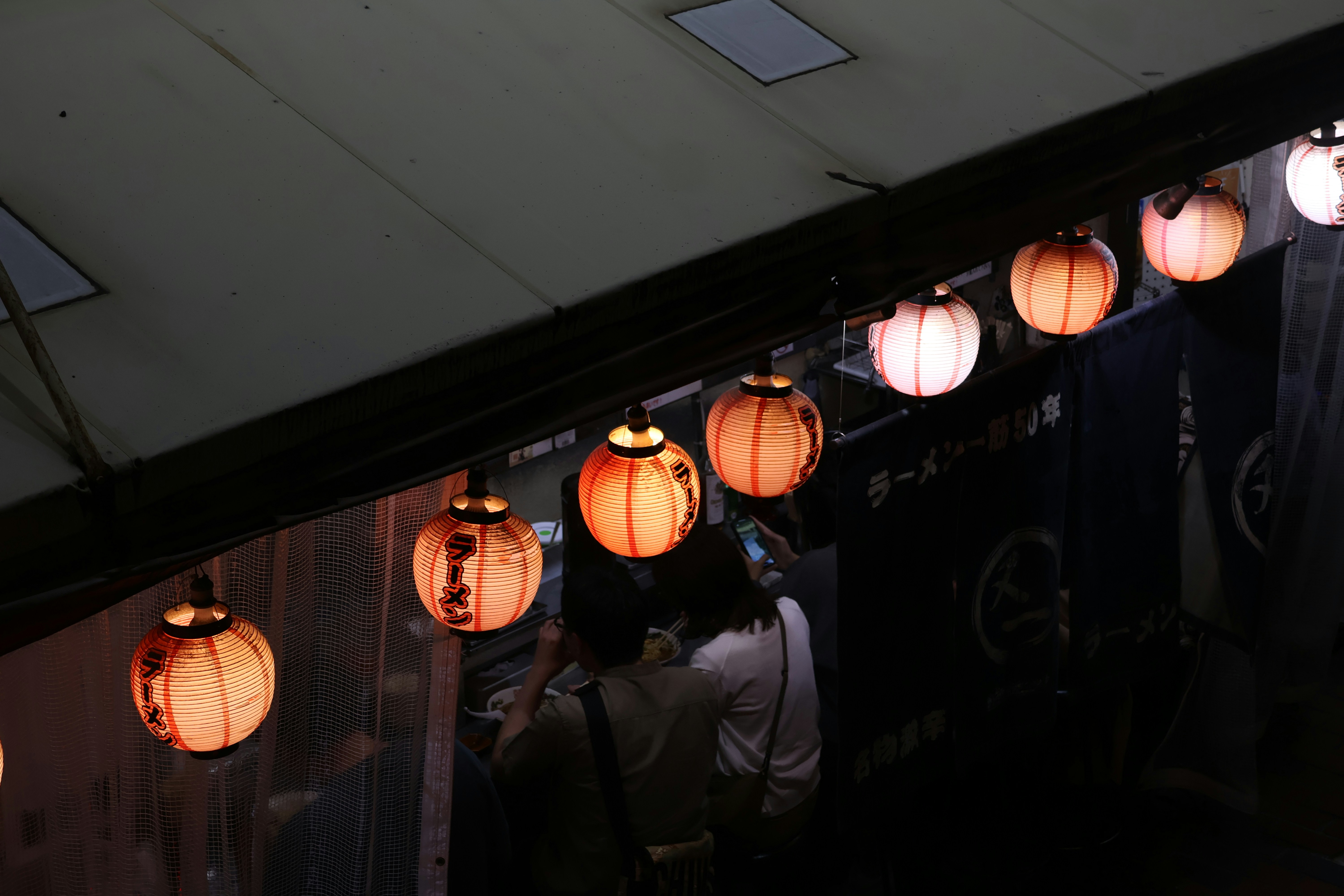 Japanese izakaya interior with customers drinking