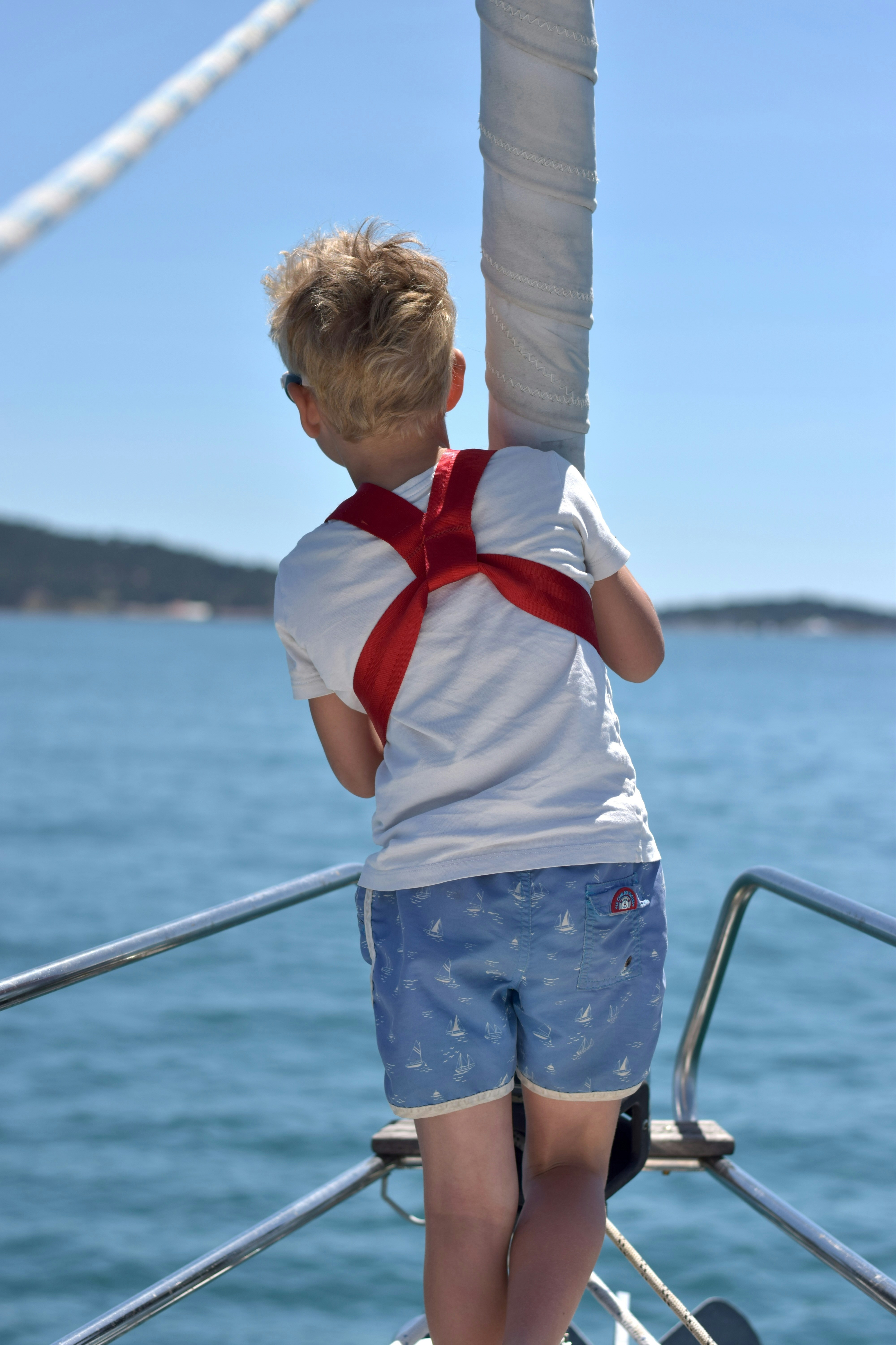 A boy observes the ocean from a boat.