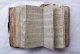 An old, handwritten book is open to view.