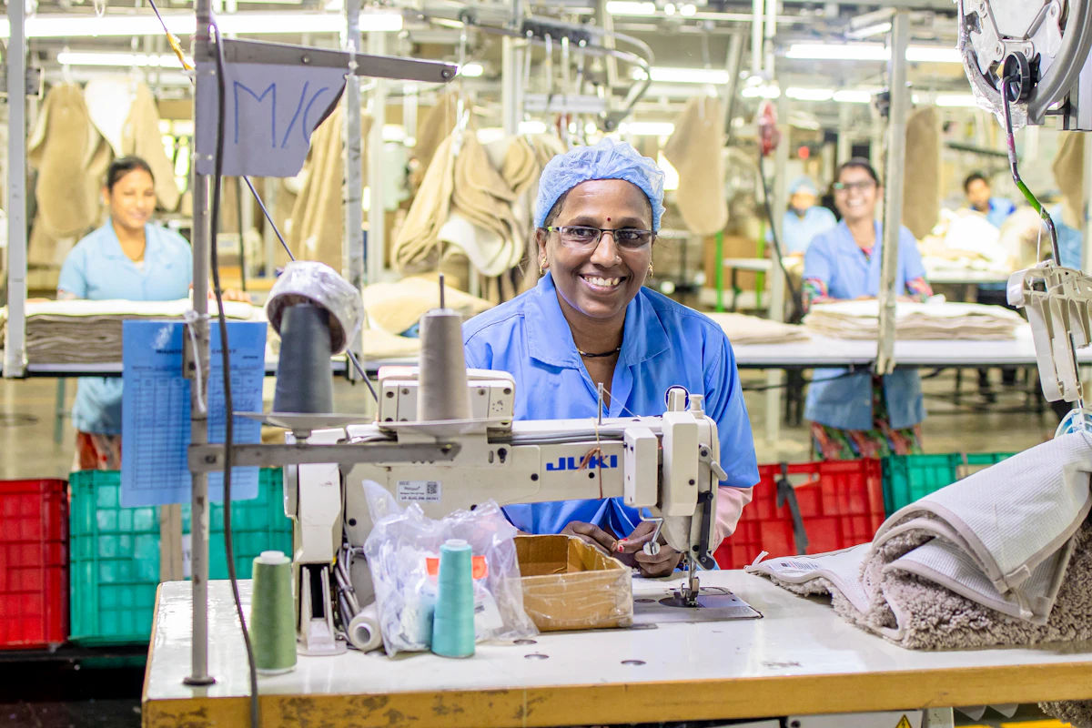 Smiling woman artisan working at a sewing machine