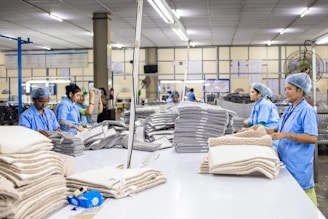 Workers are assembling textiles at a factory.